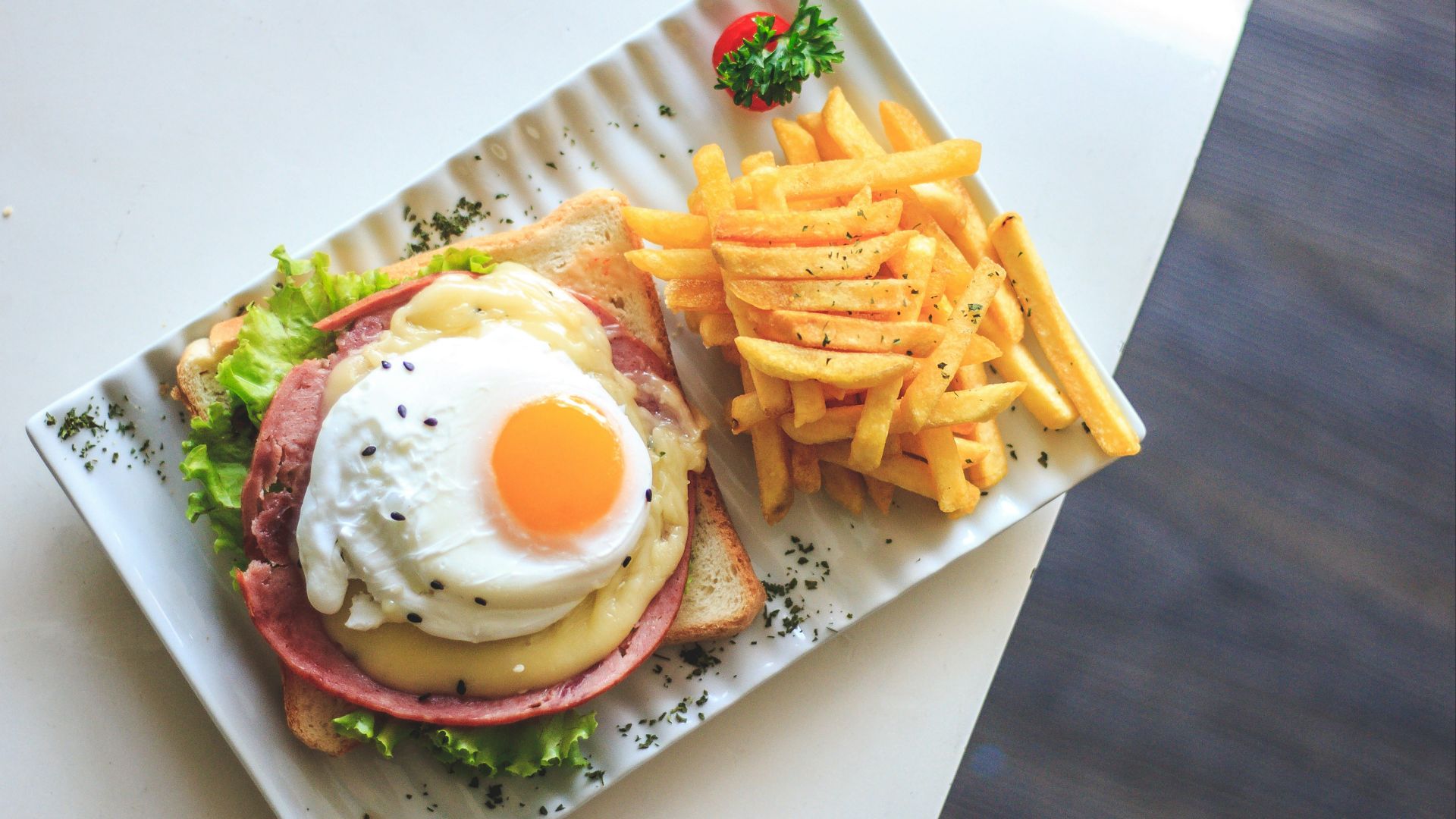 bread with egg and fries on plate