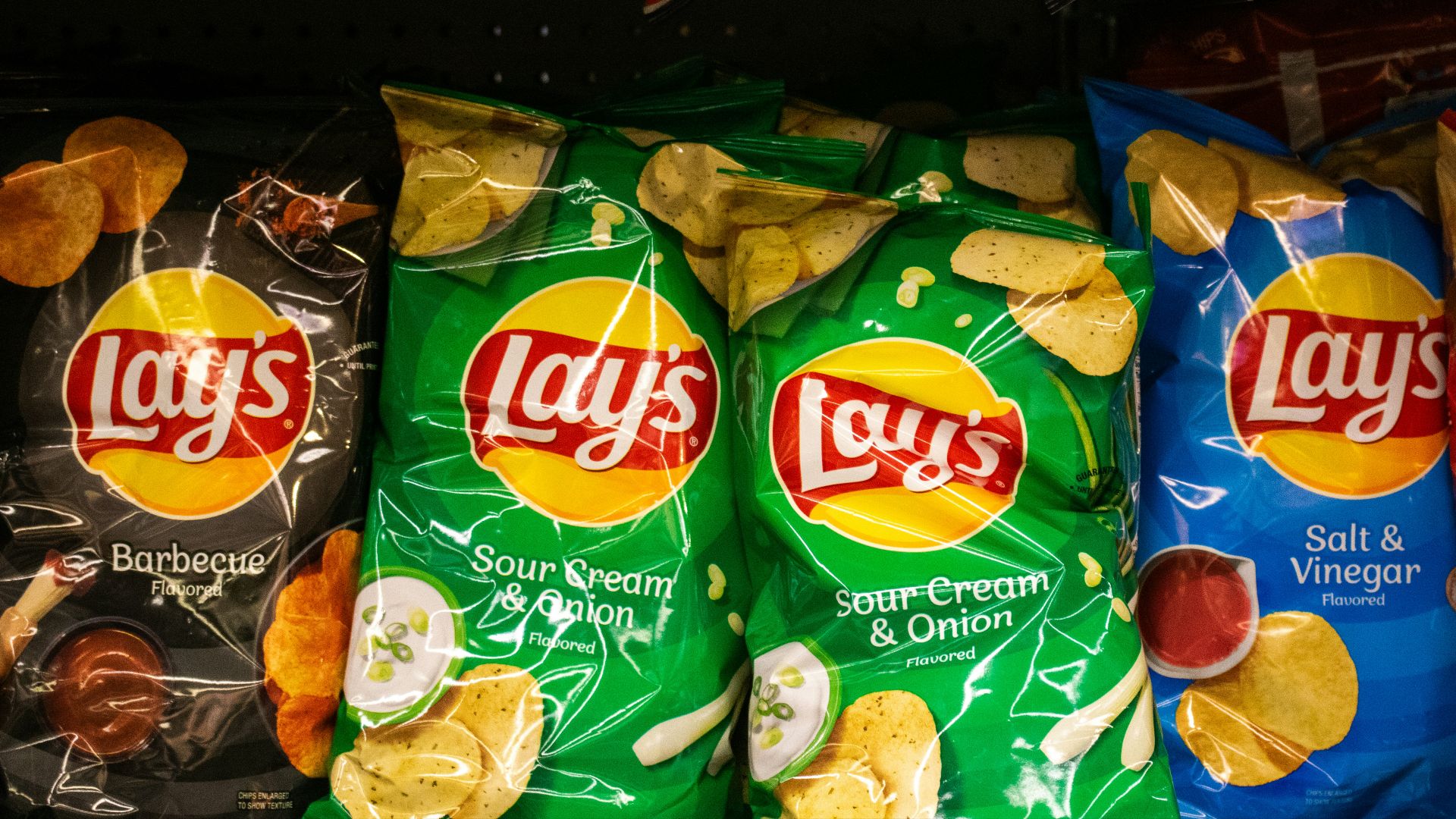 Several bags of lay's potato chips are displayed.