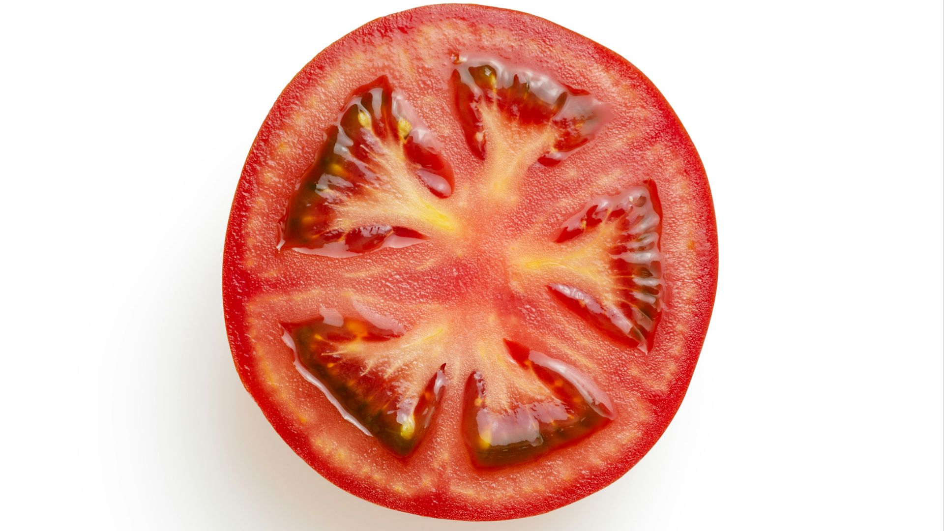 sliced tomato on white surface