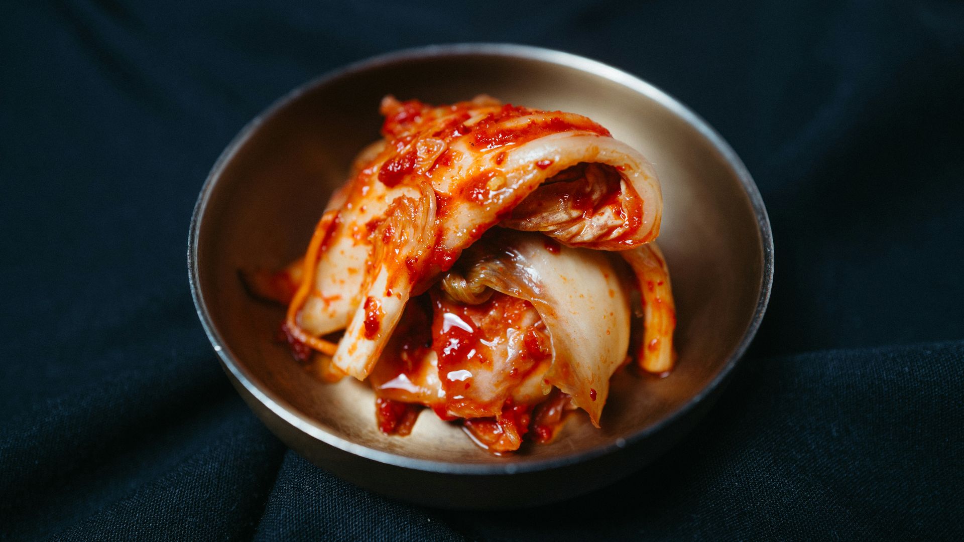 a metal bowl filled with sliced up food