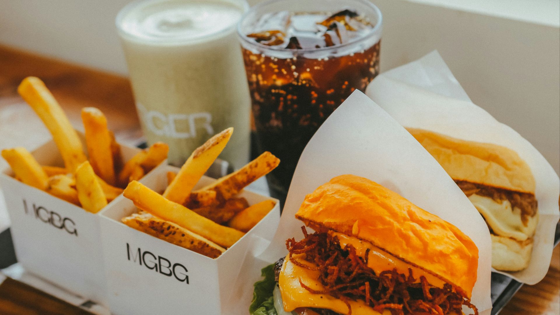 Burger, fries, and drinks on a tray