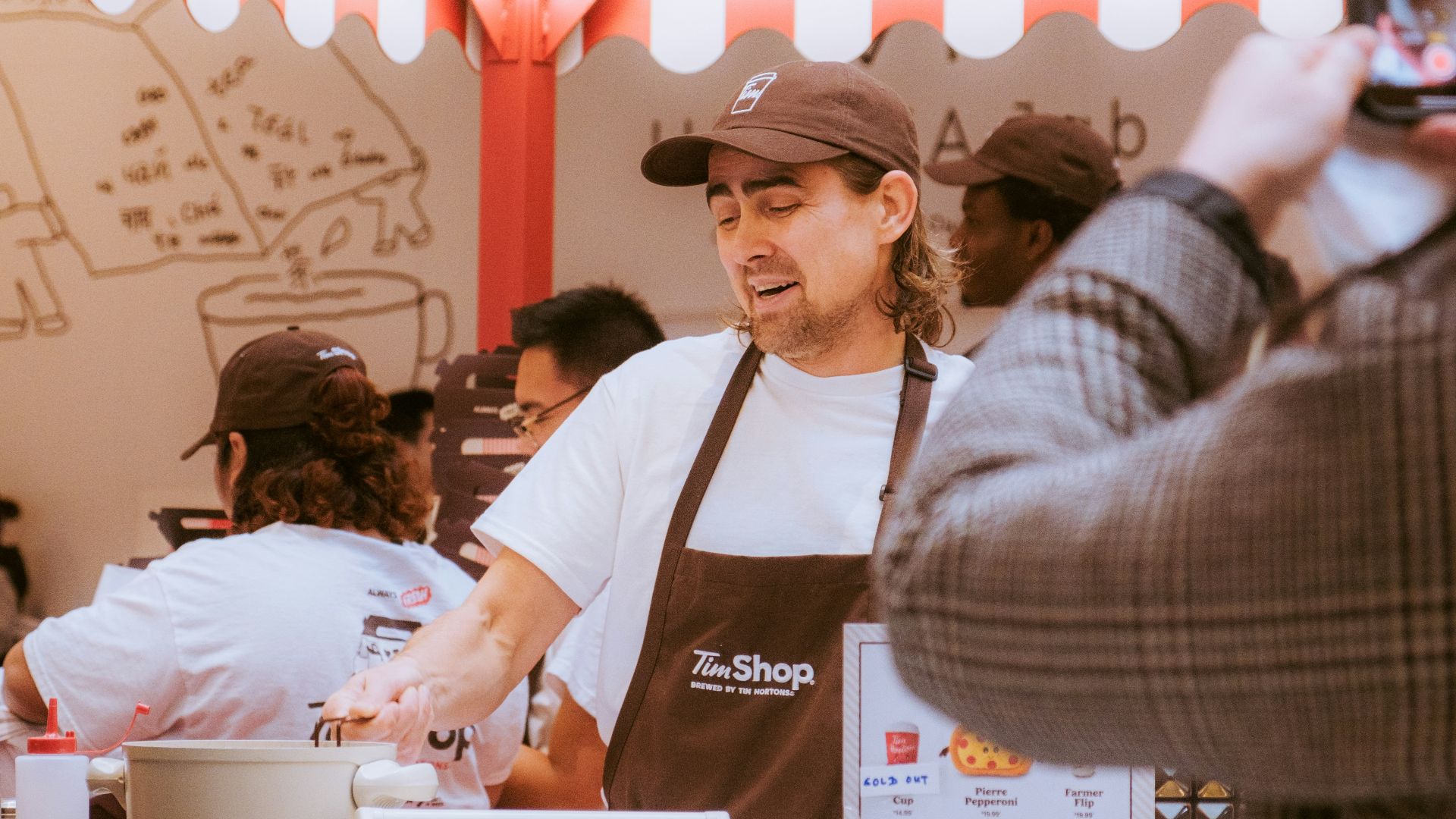Man working at a food stand preparing food