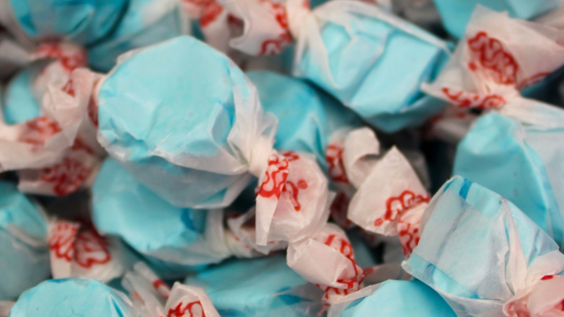 a pile of blue and white candies on top of each other