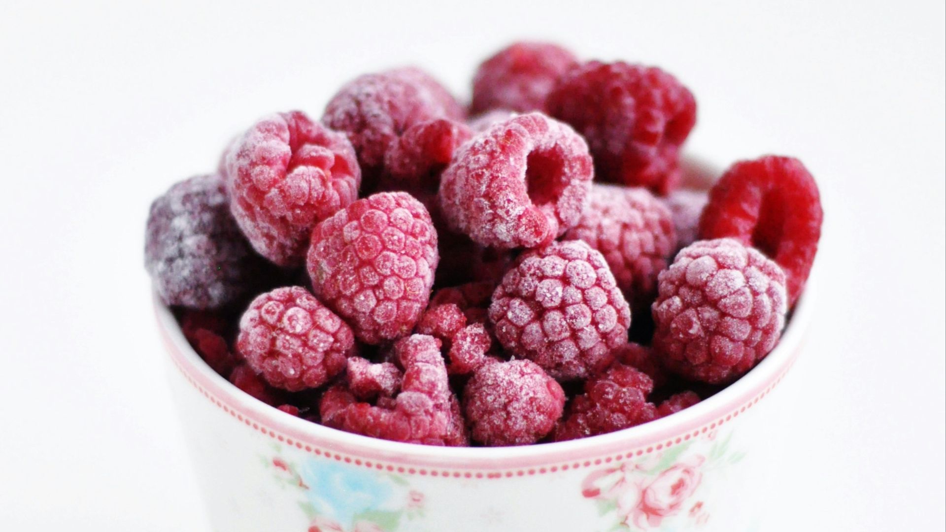 raspberry on white and pink floral ceramic cup