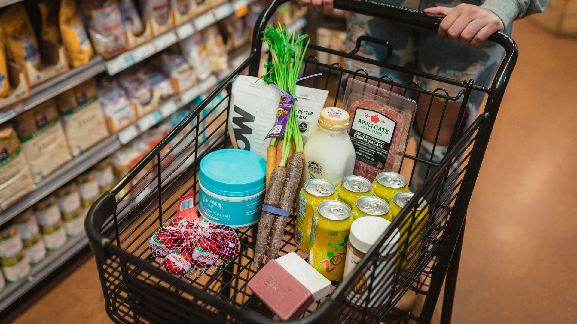 a person pushing a shopping cart full of food