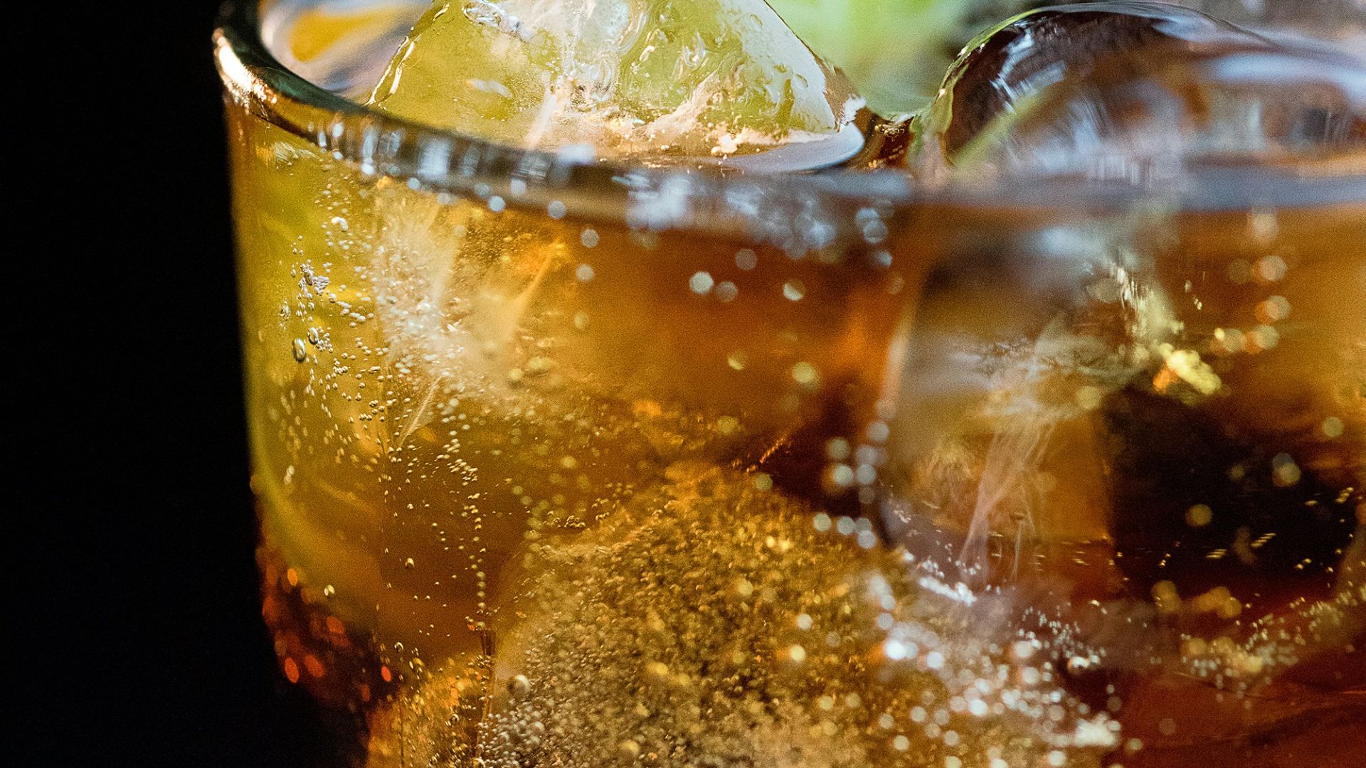 clear drinking glass with ice cubes and lemon