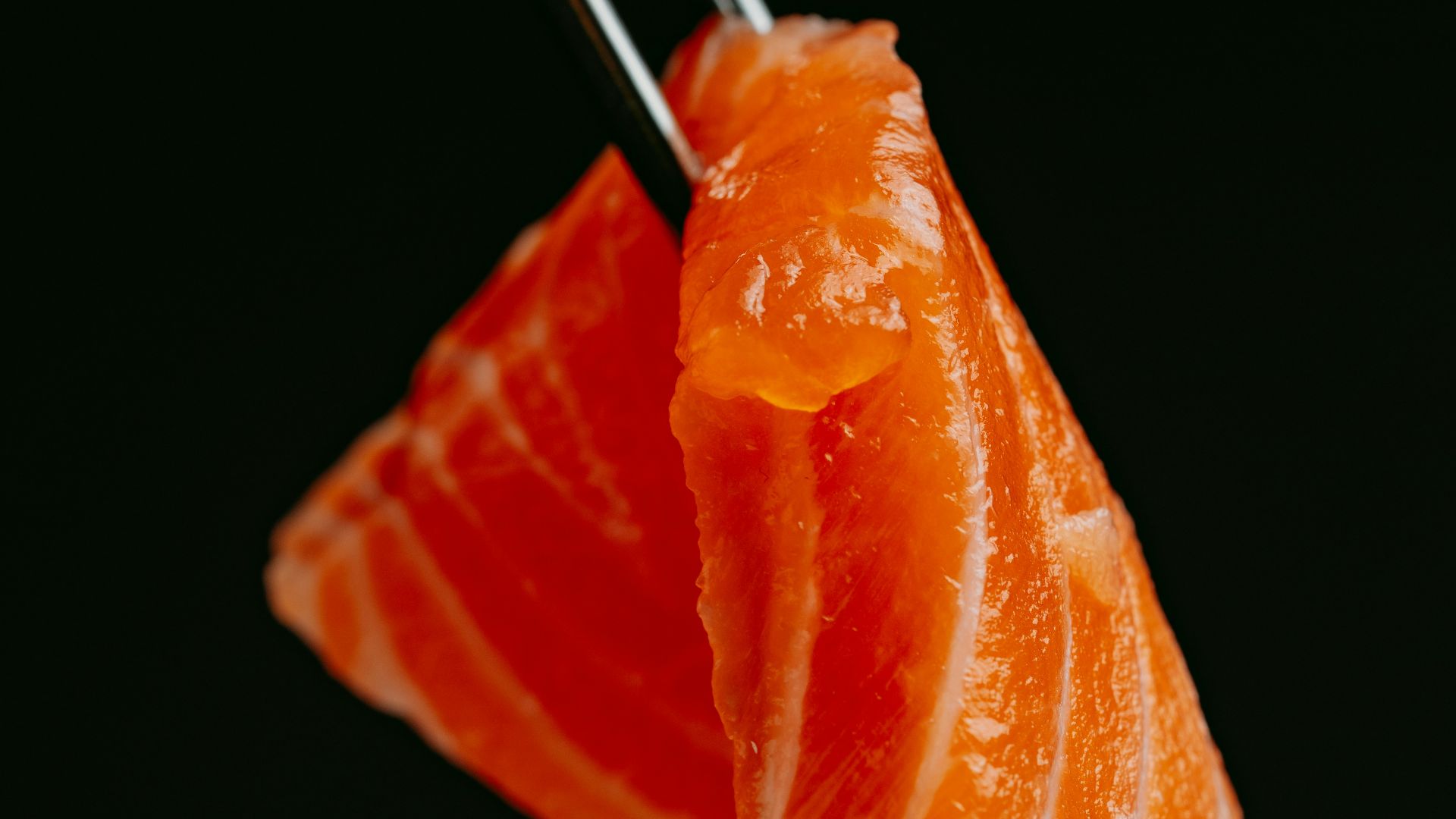 a piece of sushi with chopsticks sticking out of it