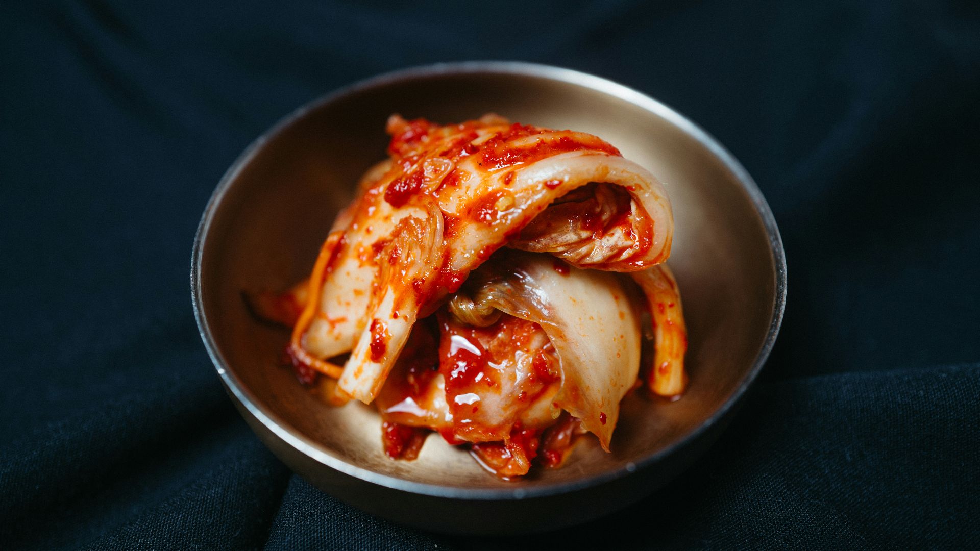 a metal bowl filled with sliced up food
