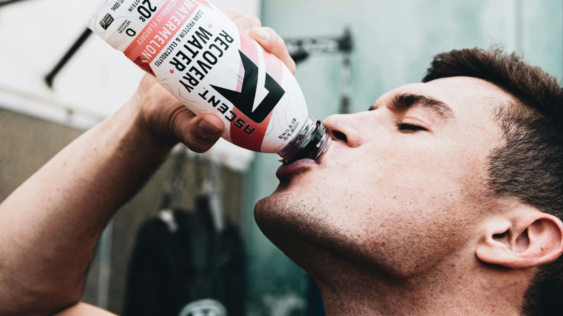 man drinking coca cola bottle
