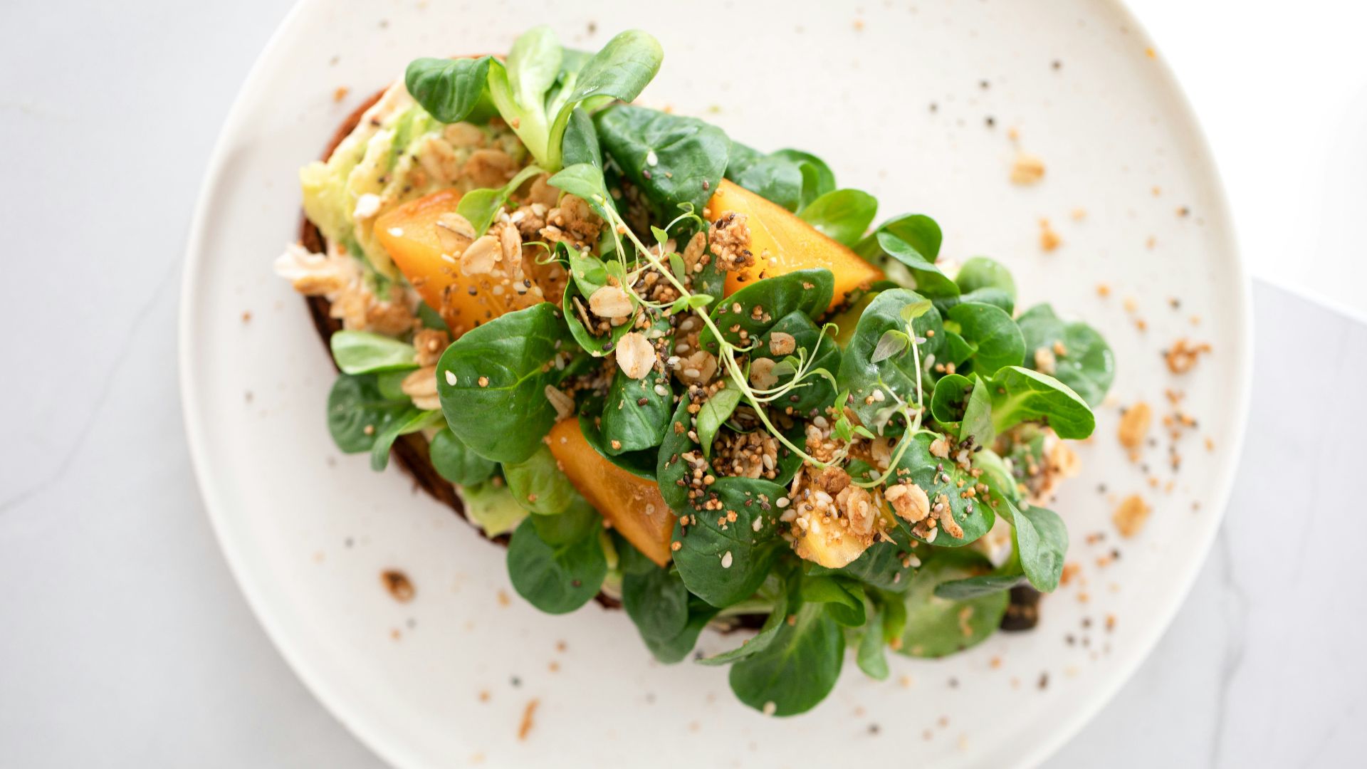 a white plate topped with a green salad