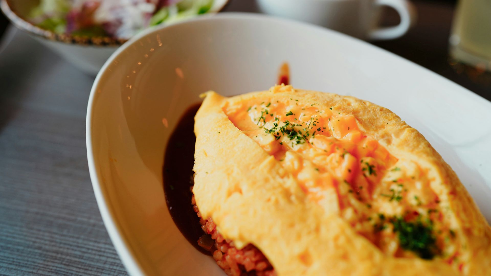 Omelet with sides and soup ready to eat.