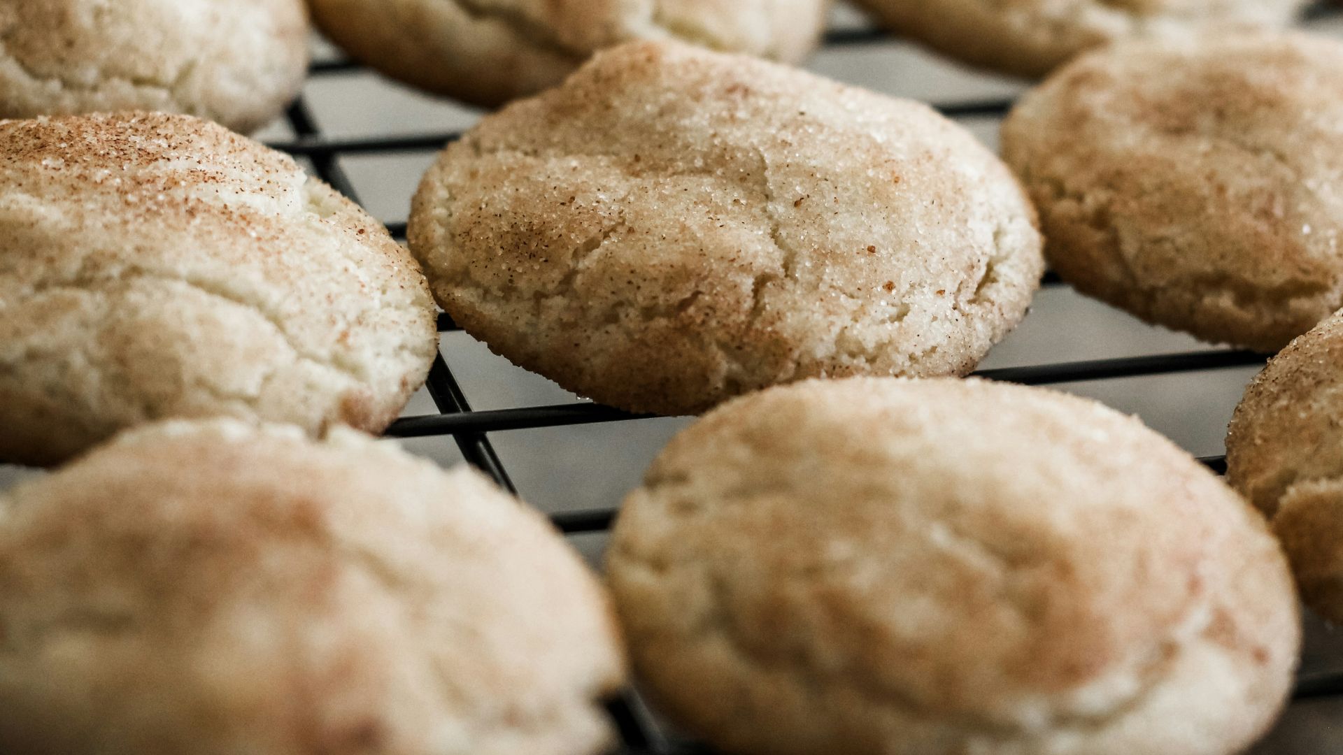 a bunch of cookies that are cooling on a rack