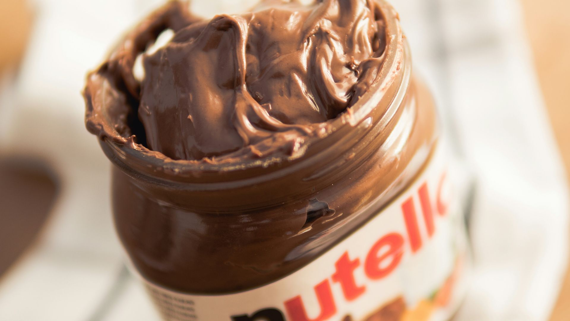 Nutella plastic container on white textile