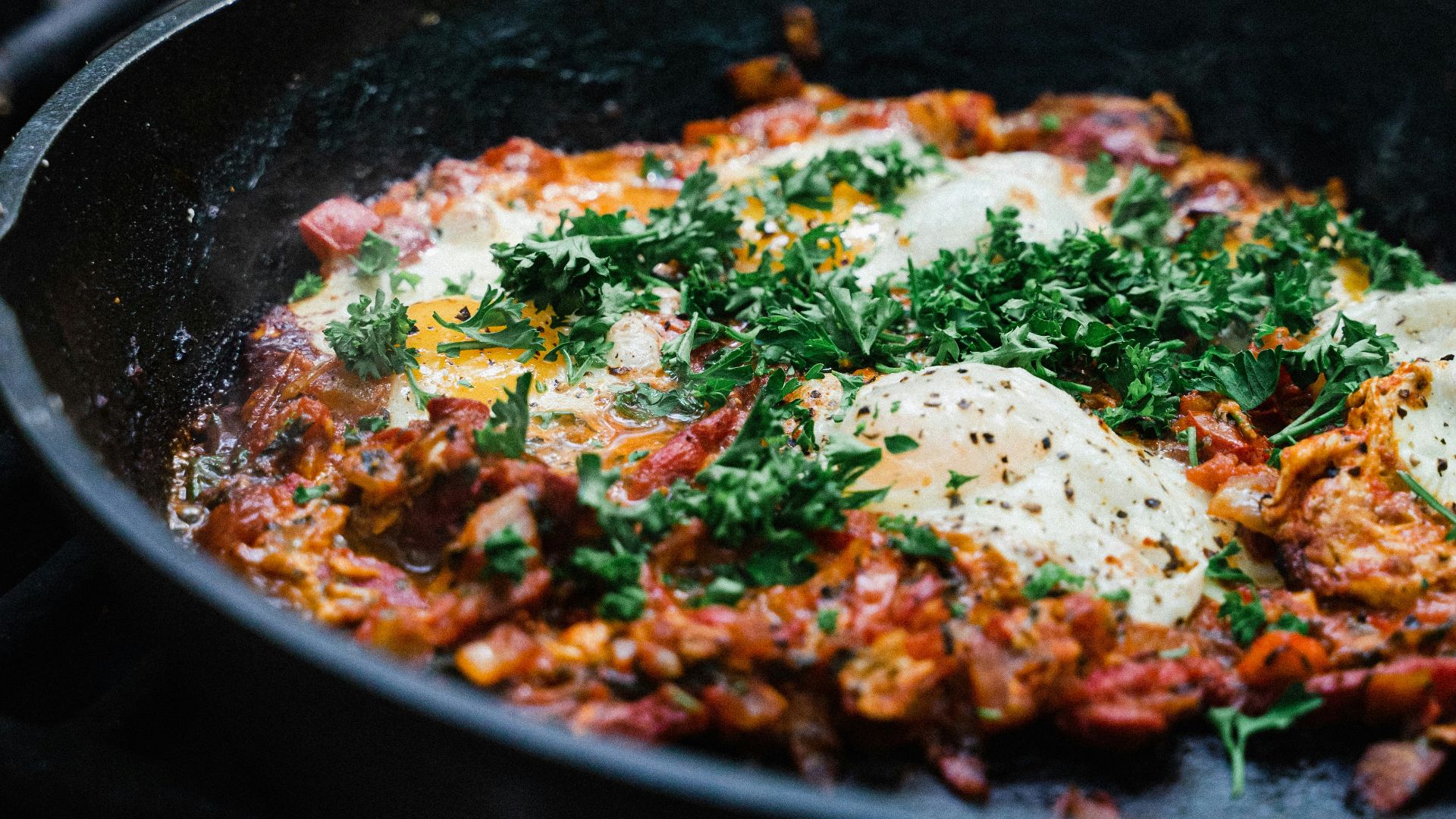 a skillet filled with eggs on top of a stove