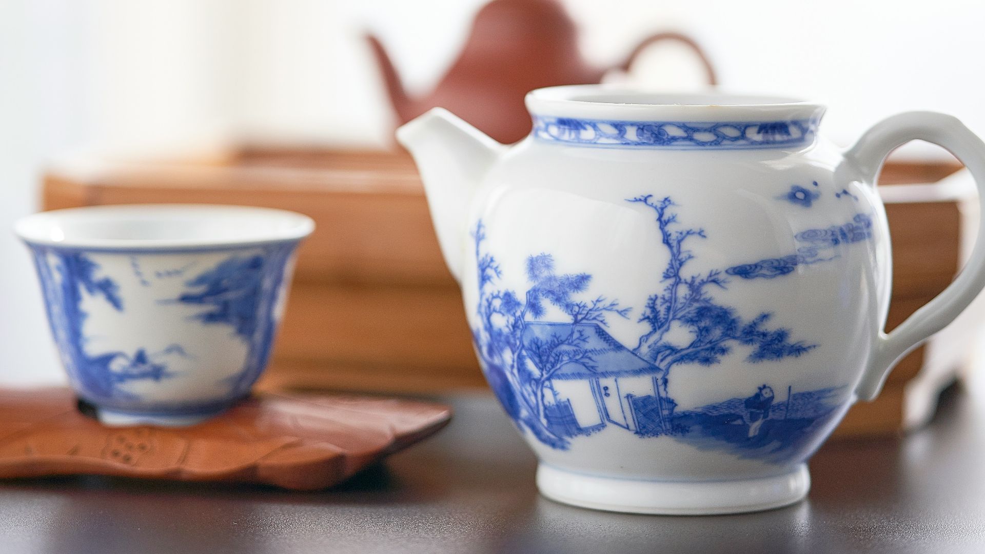 selective focus photography of ceramic teapot and teacup