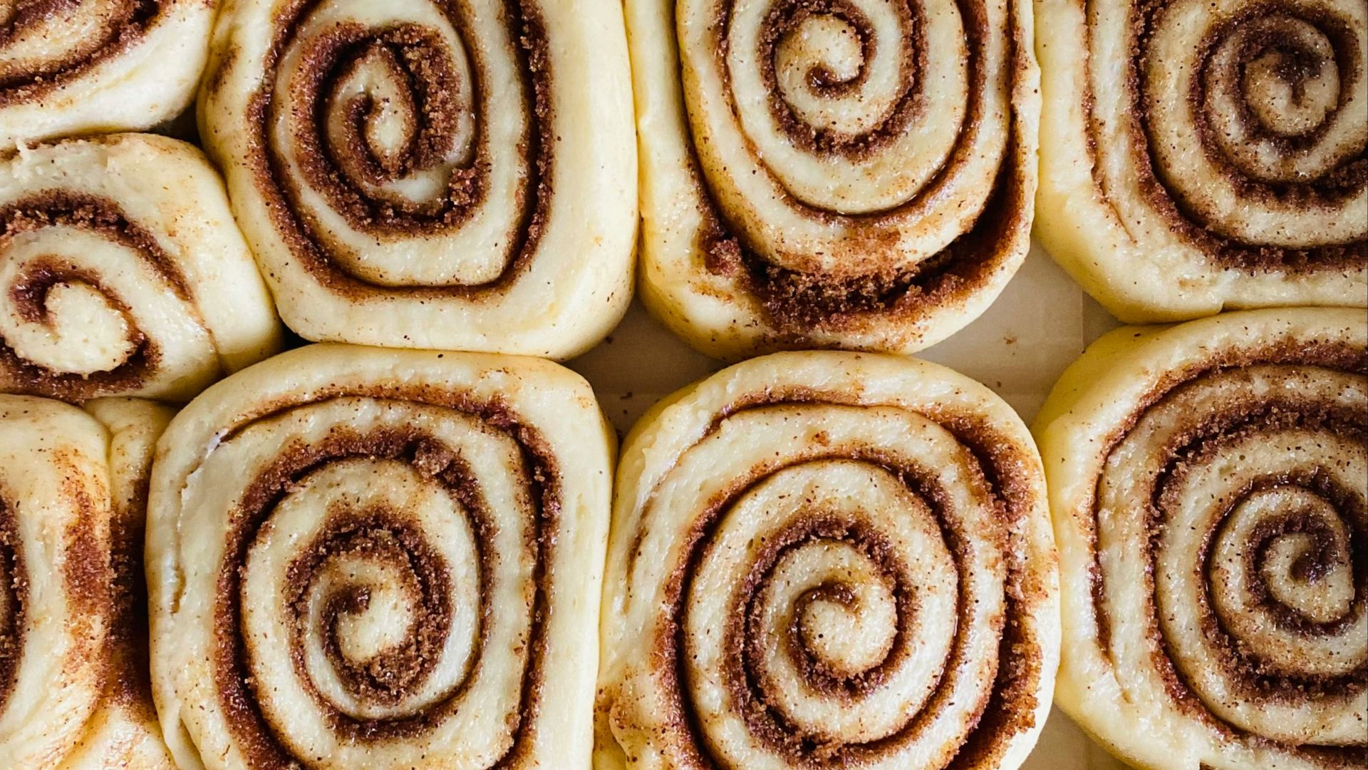 a close up of a plate of cinnamon rolls