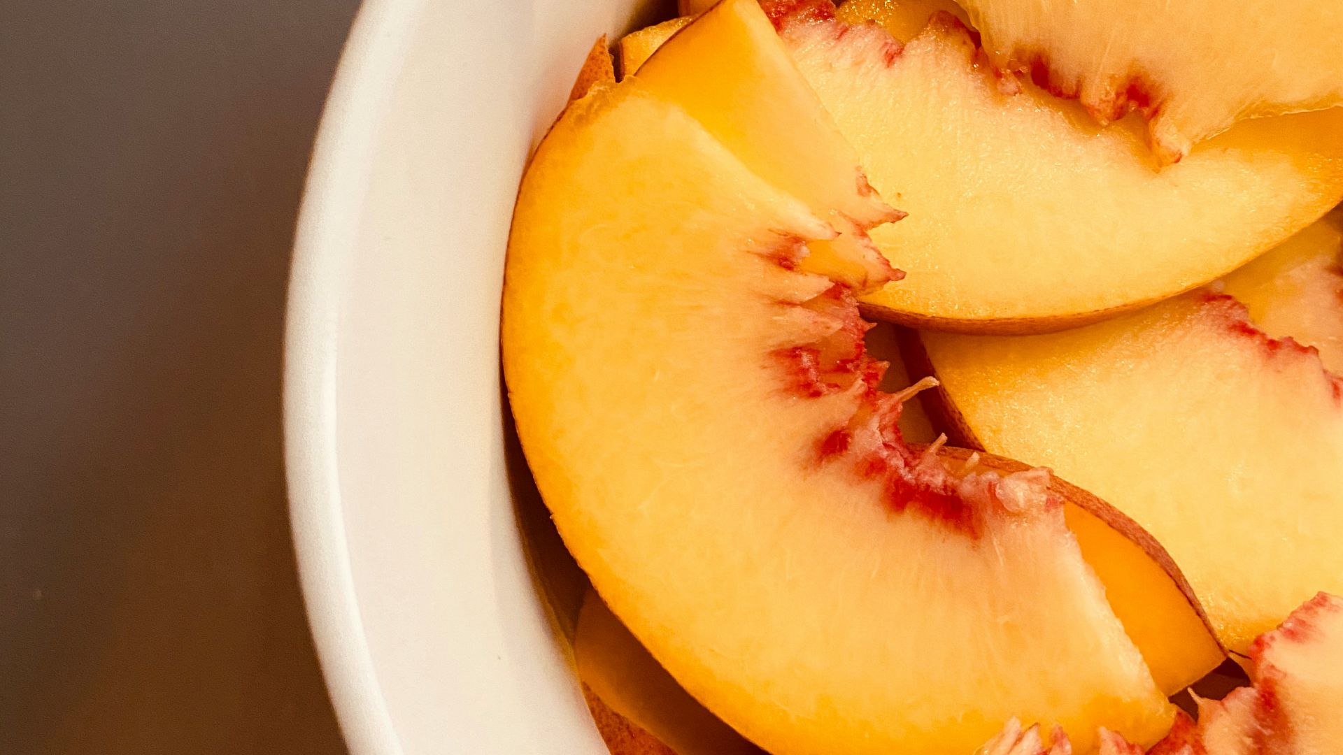 sliced fruit in white ceramic bowl