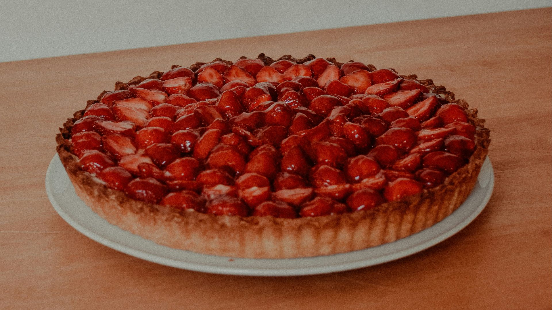 red and white round fruit on brown wooden table