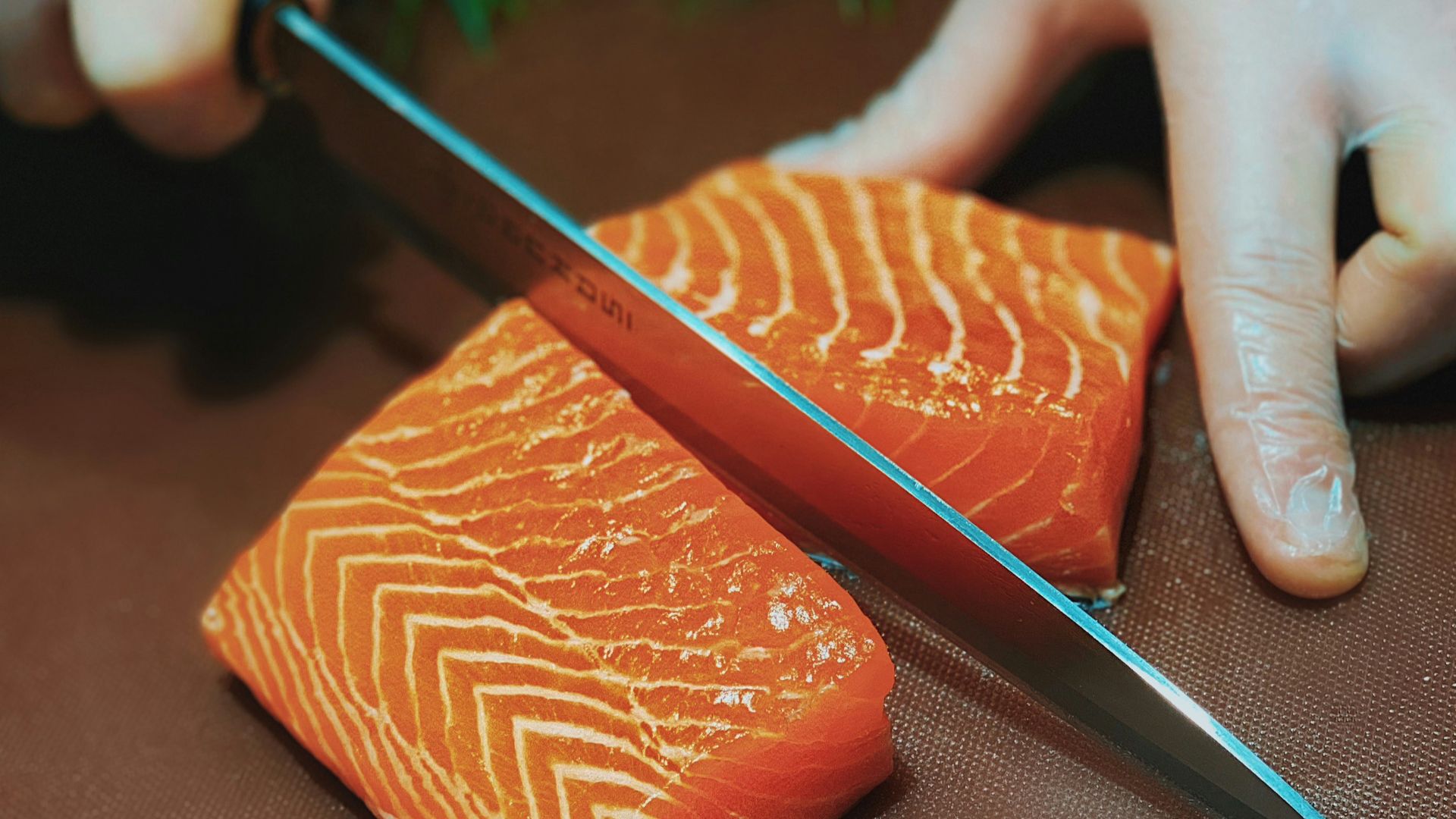 person holding black pencil and brown leather case