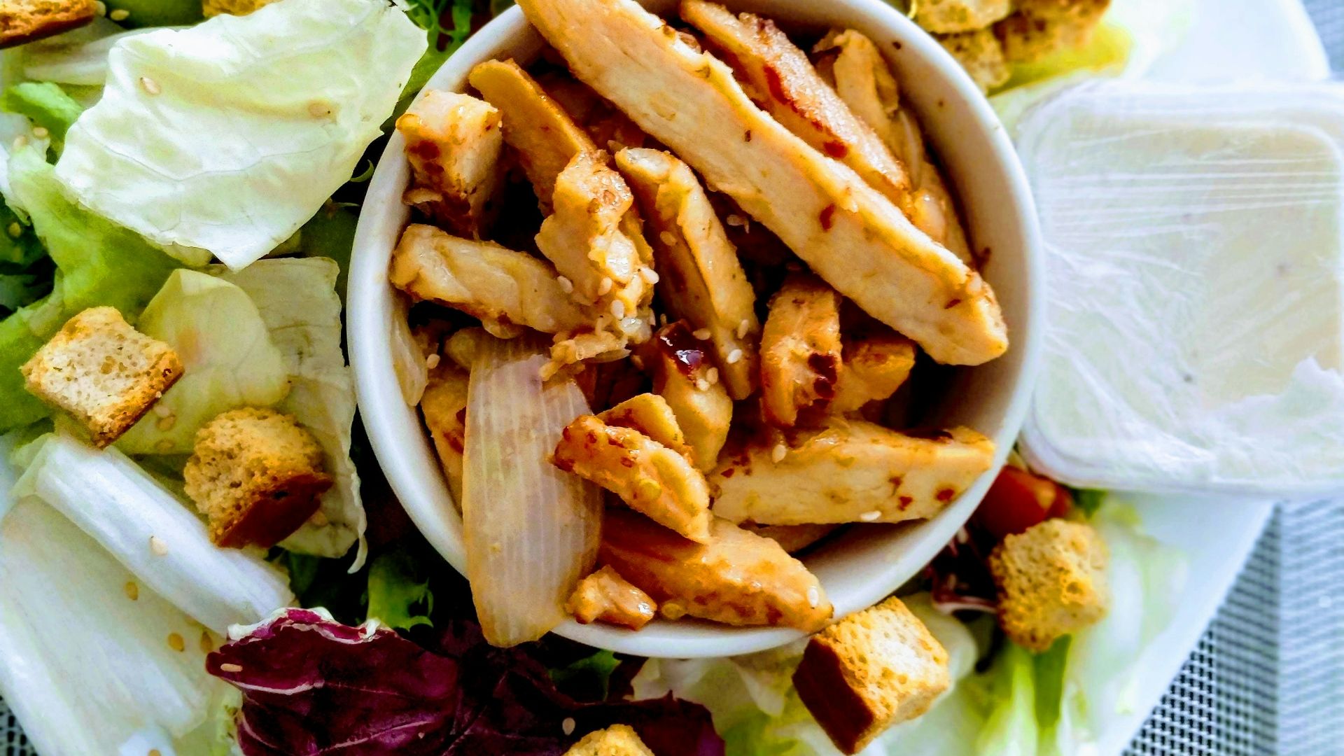 sliced meat and vegetable salad on white ceramic plate