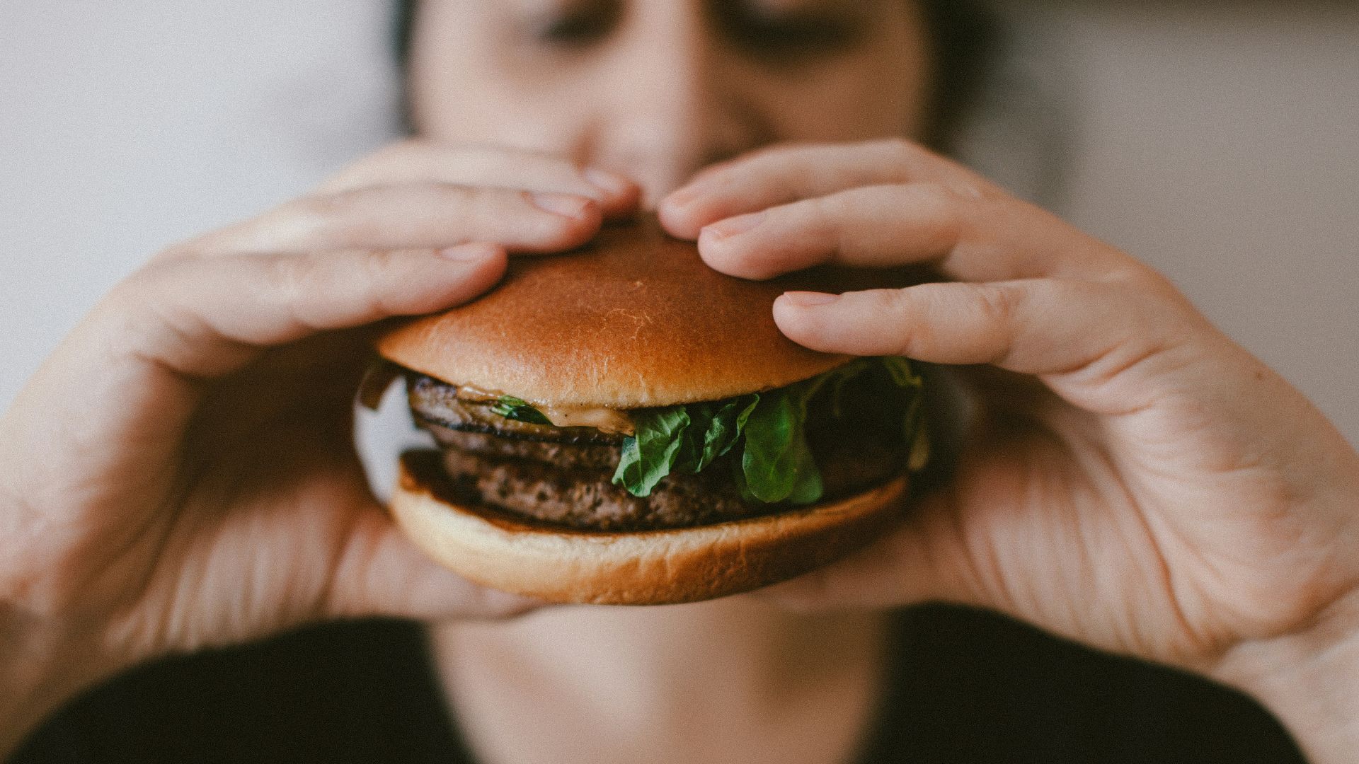 person holding burger