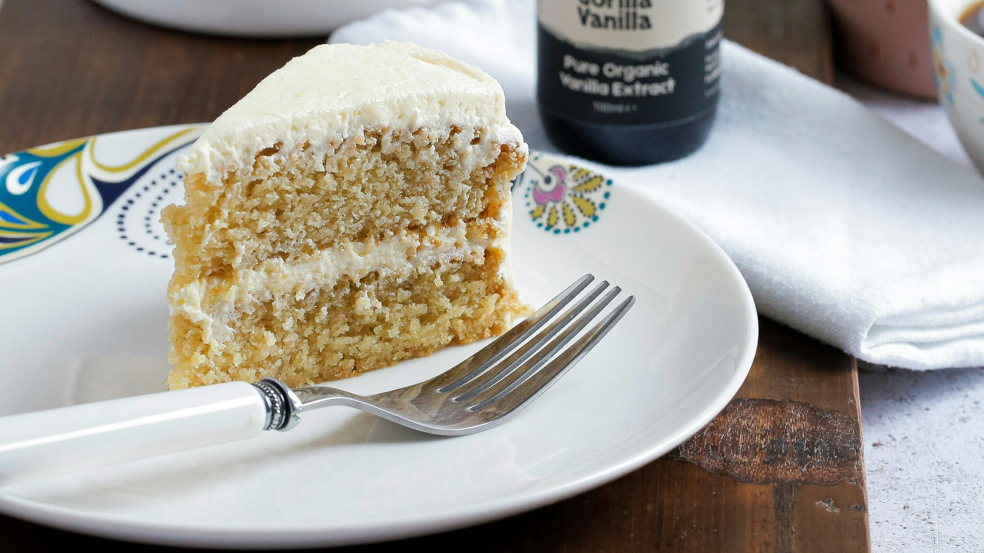 black glass bottle beside white ceramic plate with bread