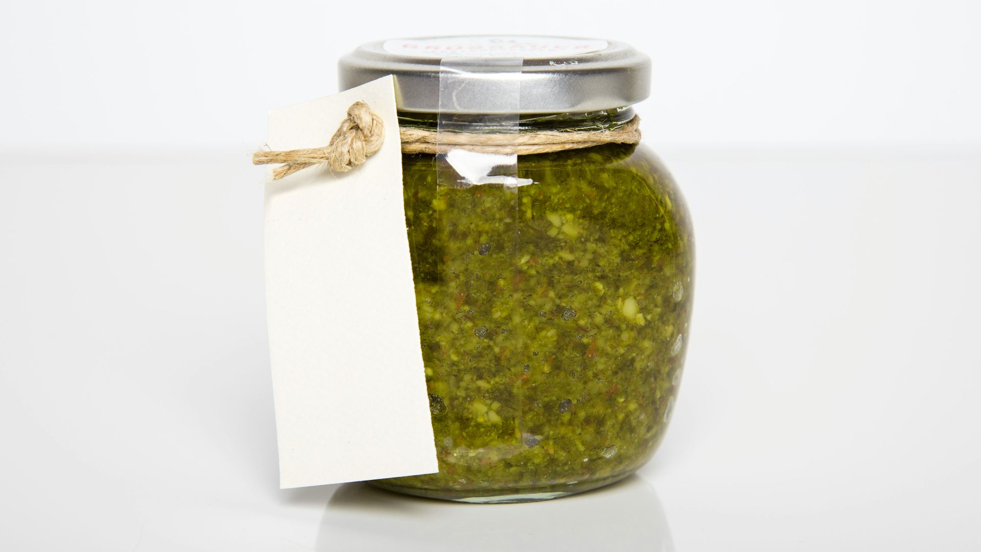 clear glass jar with green kush inside
