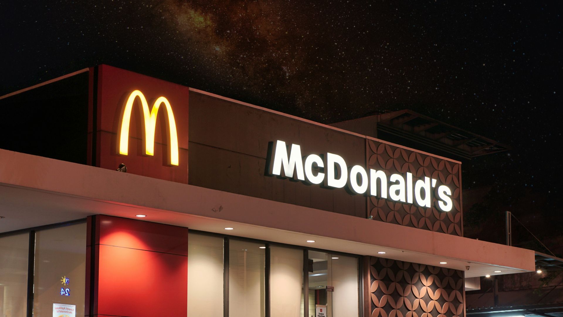 a mcdonald's restaurant is lit up at night