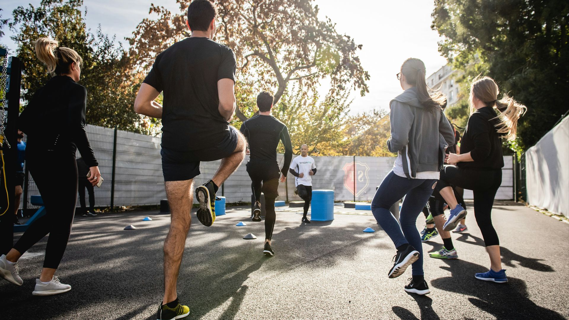 man in black t-shirt and black shorts running on road during daytime