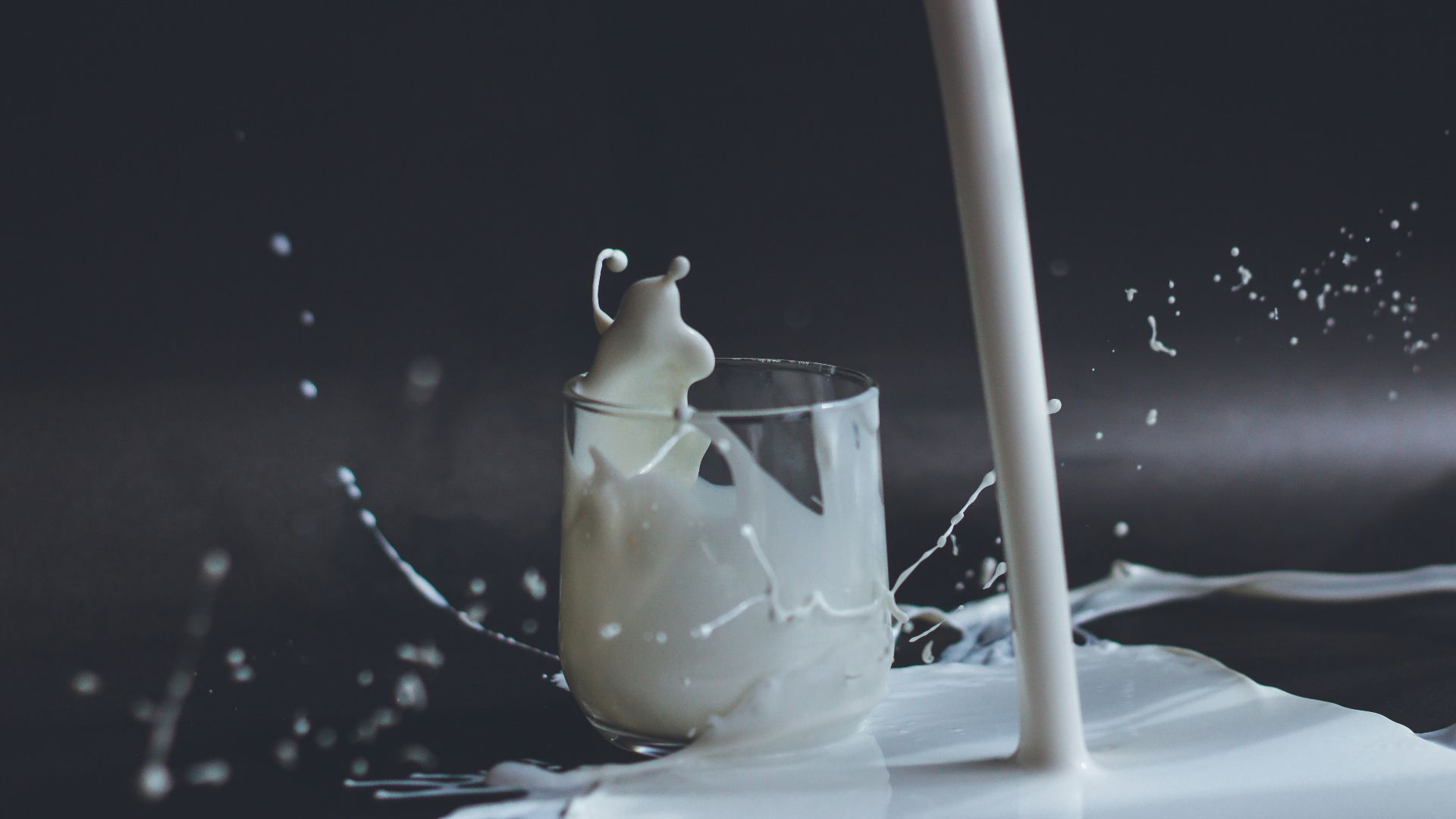 white candle in clear glass holder