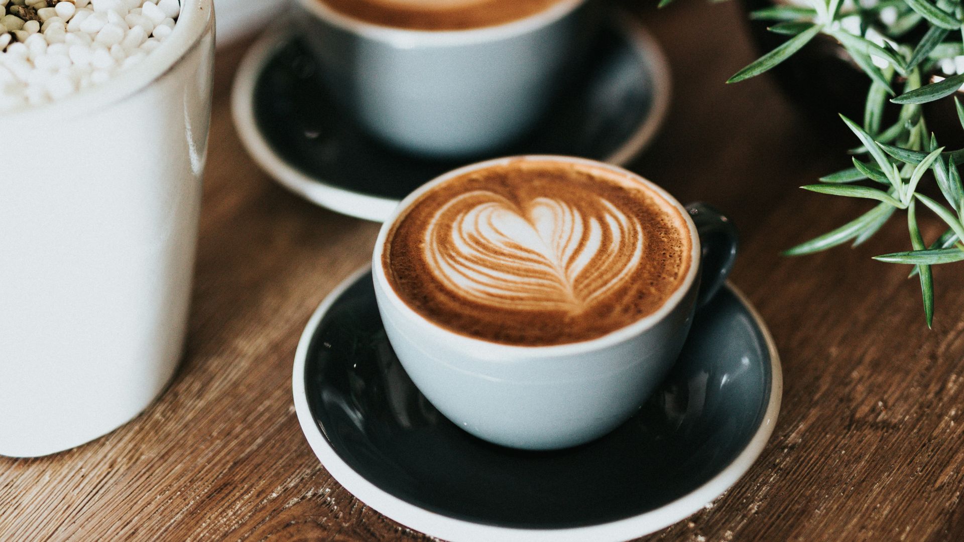 shallow focus photography of coffee late in mug on table