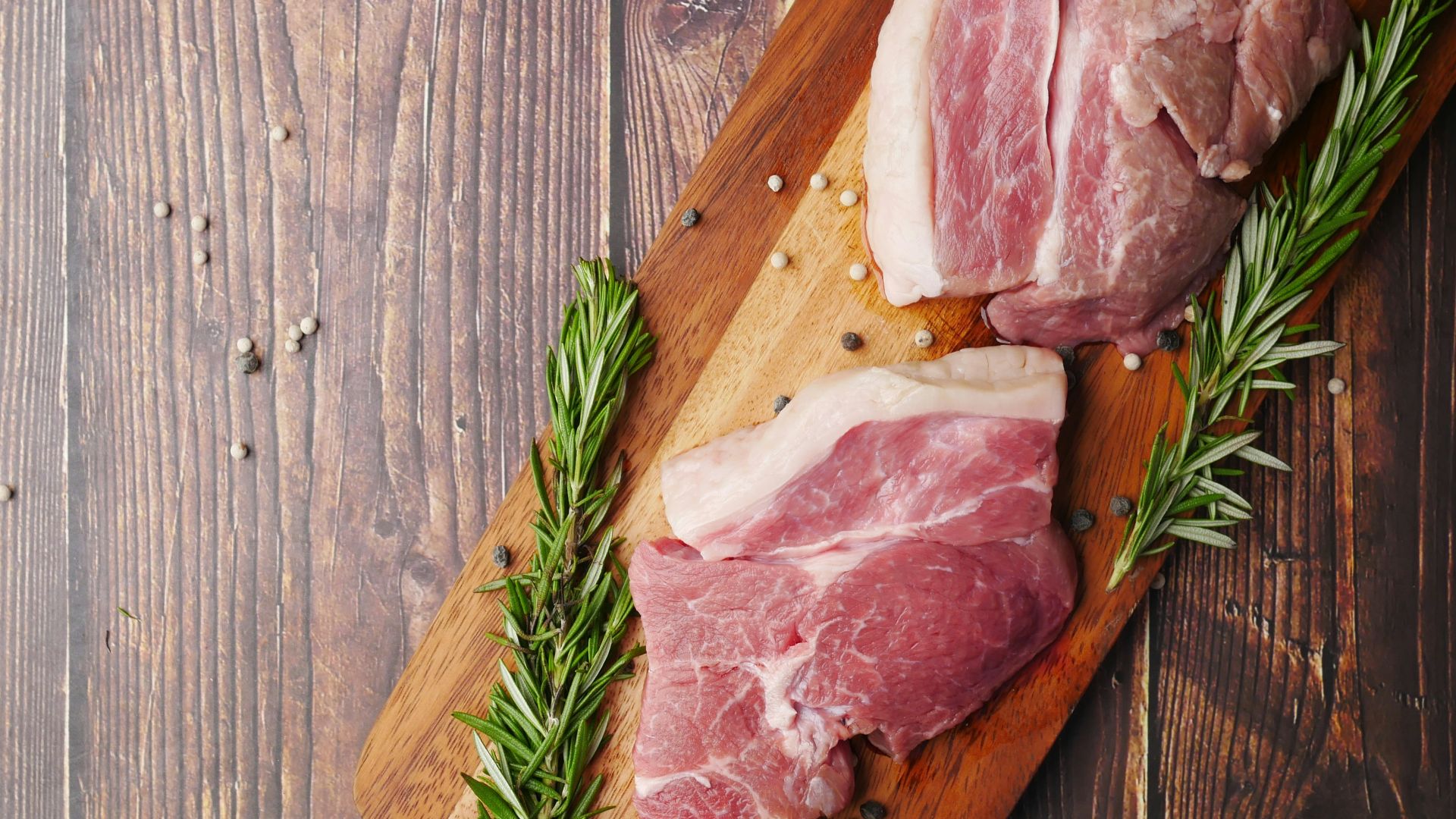 raw meat on brown wooden chopping board