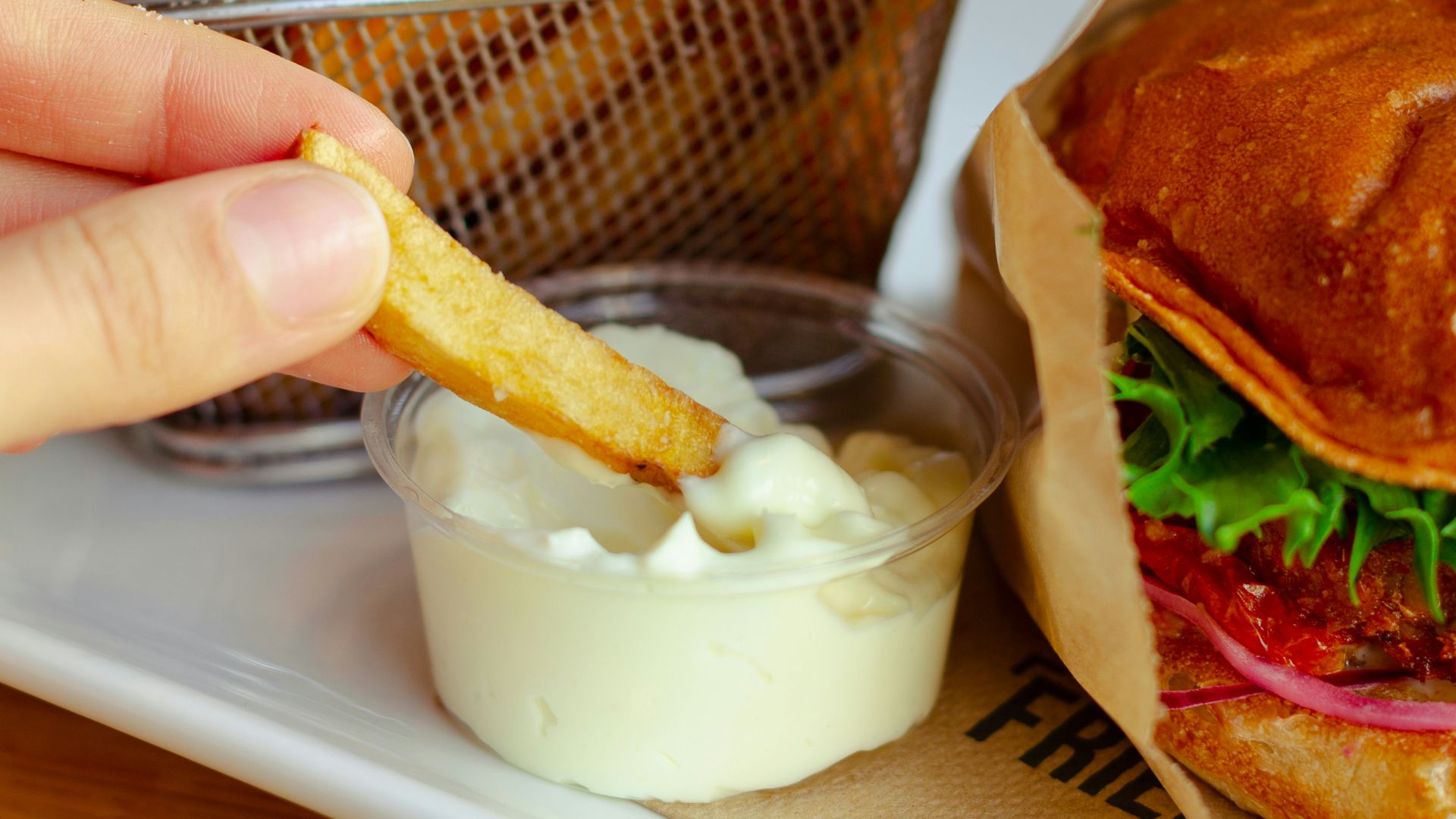 burger with cheese and vegetable on stainless steel tray