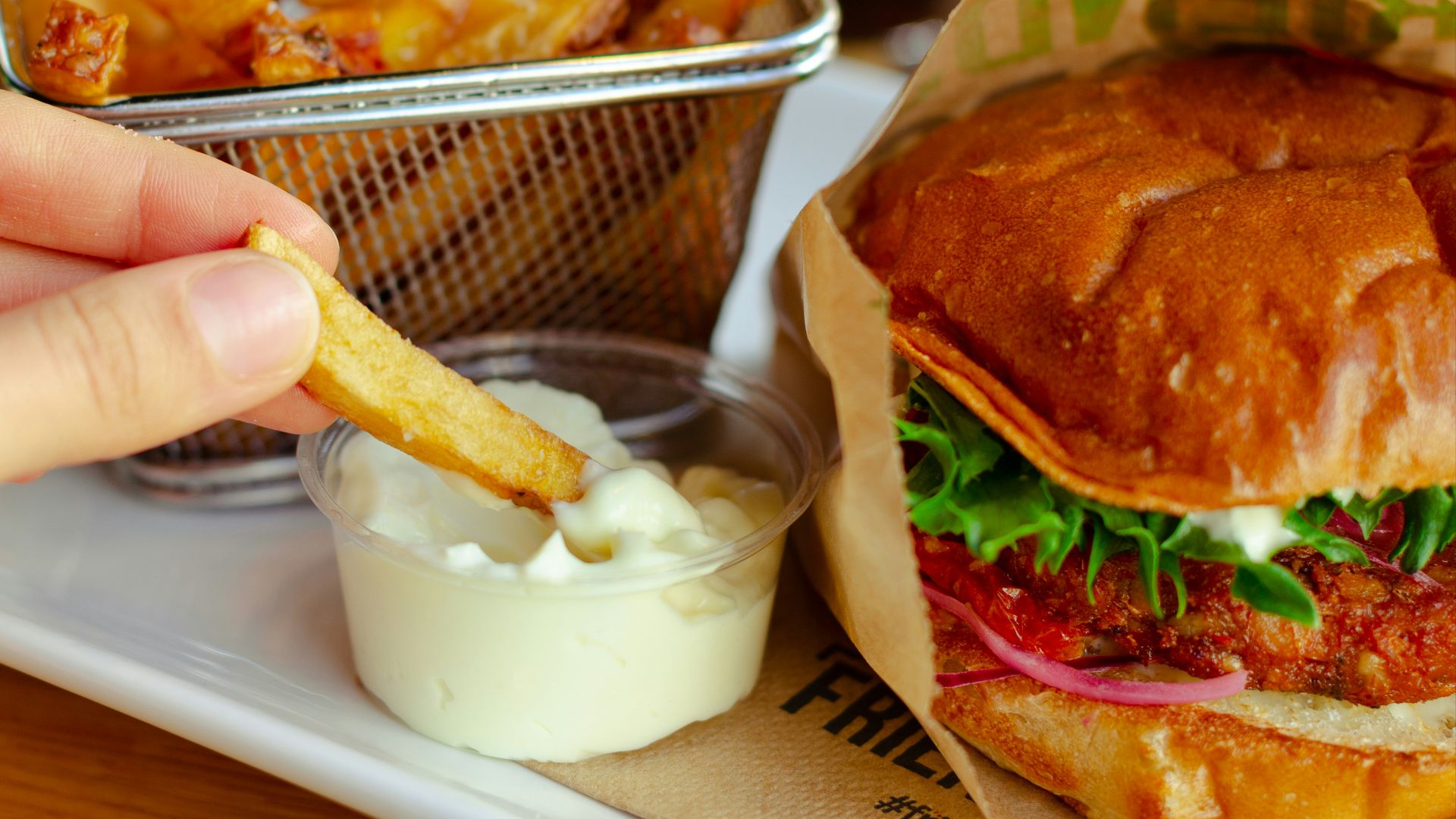 burger with cheese and vegetable on stainless steel tray