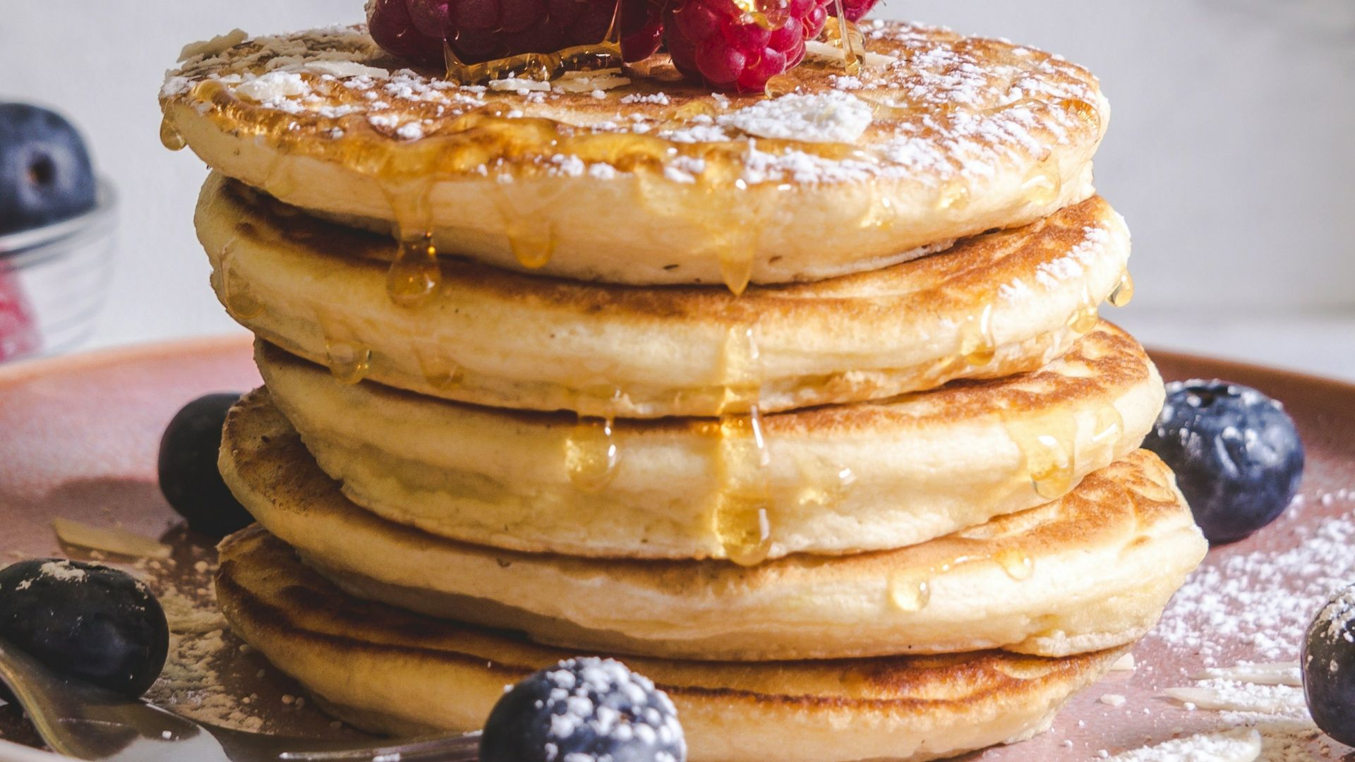pancakes with berries on white ceramic plate
