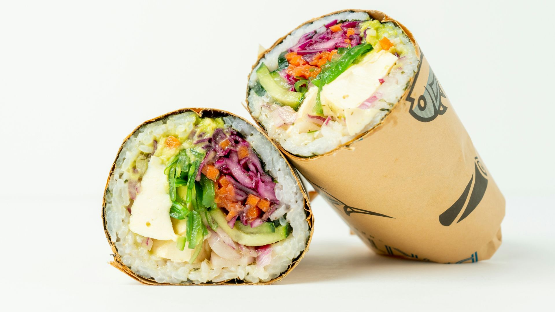 Two sushi rolls sitting next to each other on a white surface