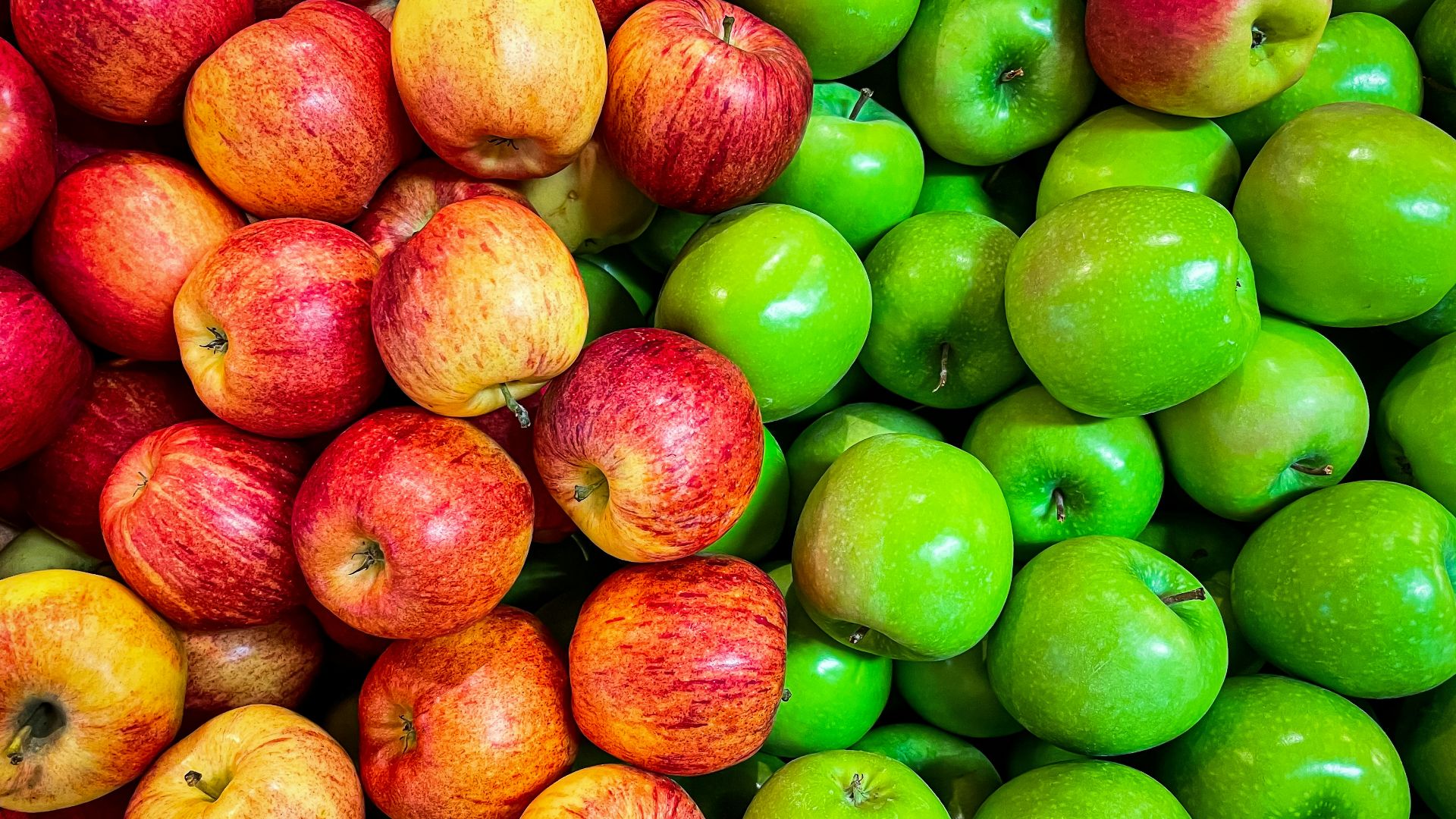 green and red apples on white plastic container