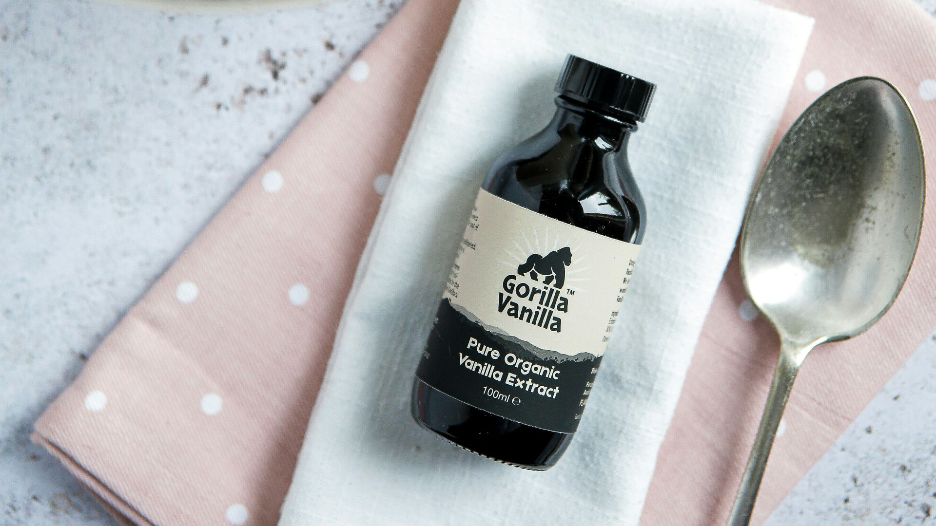 stainless steel spoon beside black glass bottle