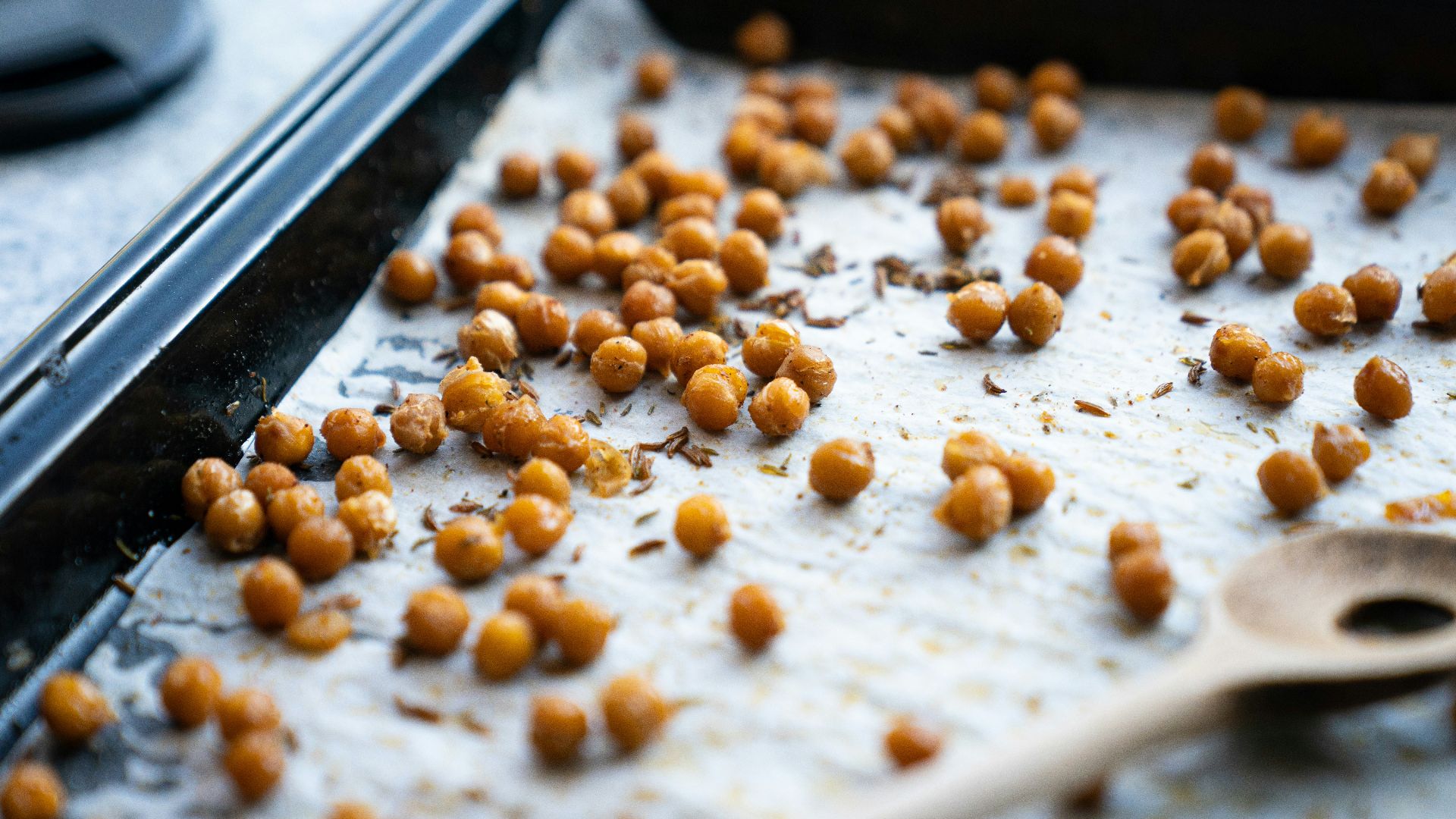 a pan filled with chickpeas and a wooden spoon