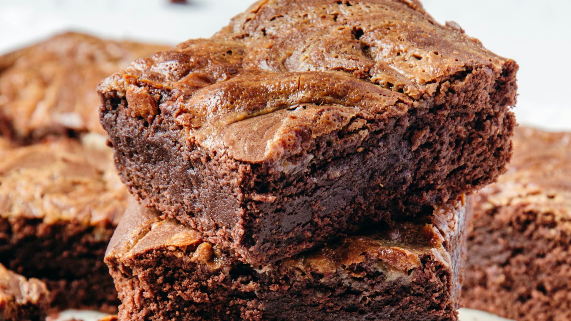 a pile of brownies sitting on top of a white plate