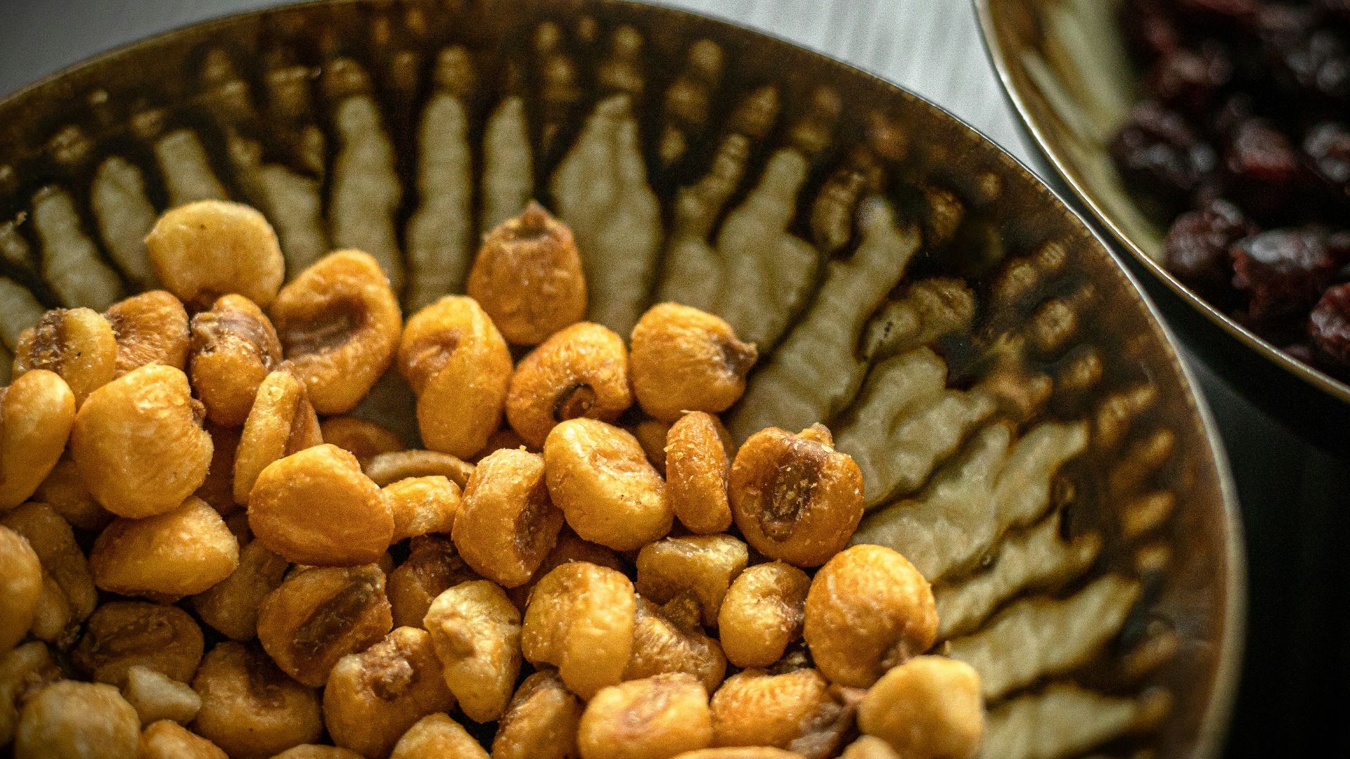 brown peanuts on black ceramic bowl