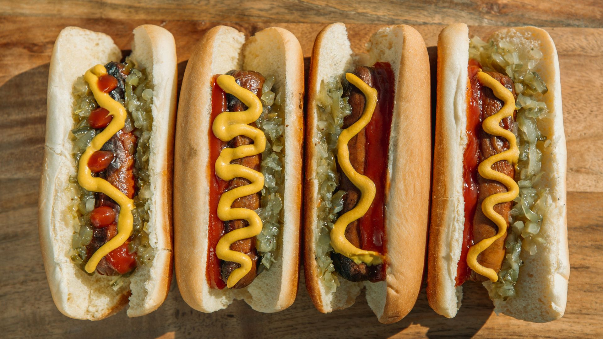 hotdog sandwich on brown wooden table
