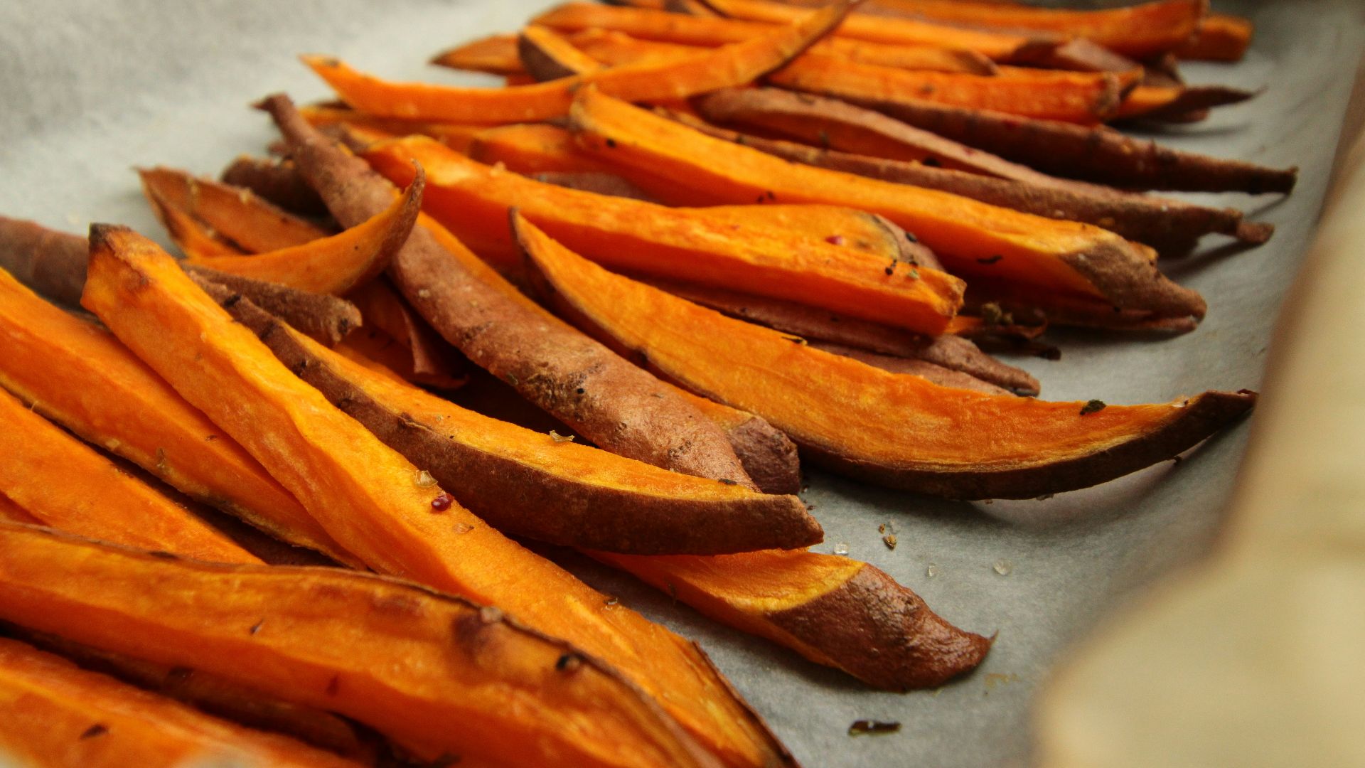 sliced orange fruit on white table