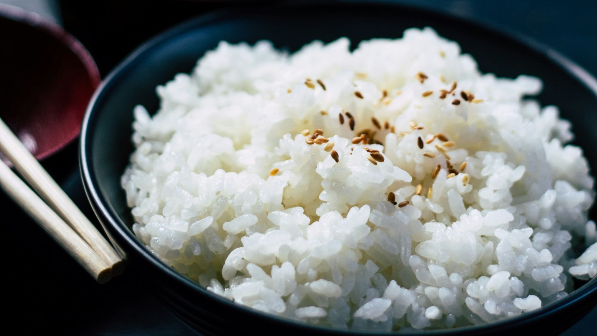rice with sesame in black bowl