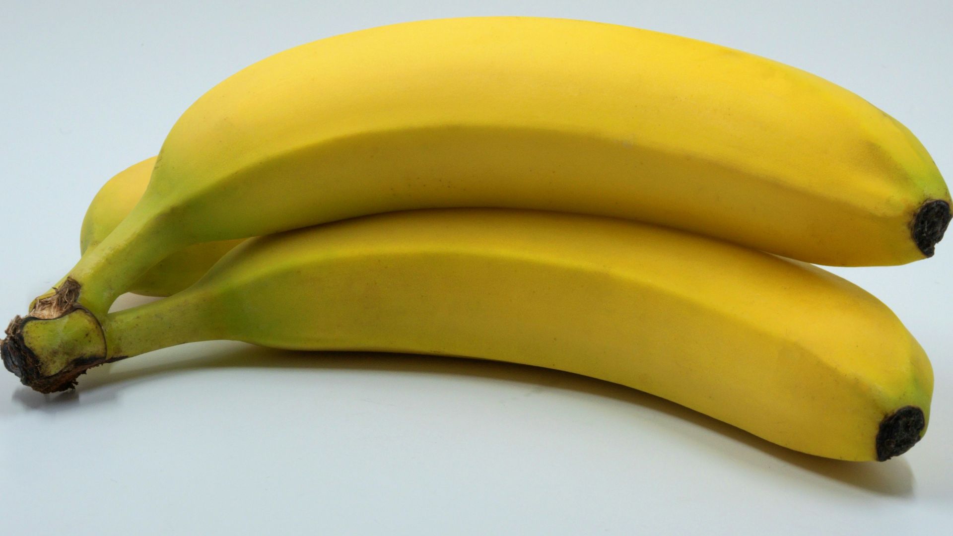 three banana fruits on white background