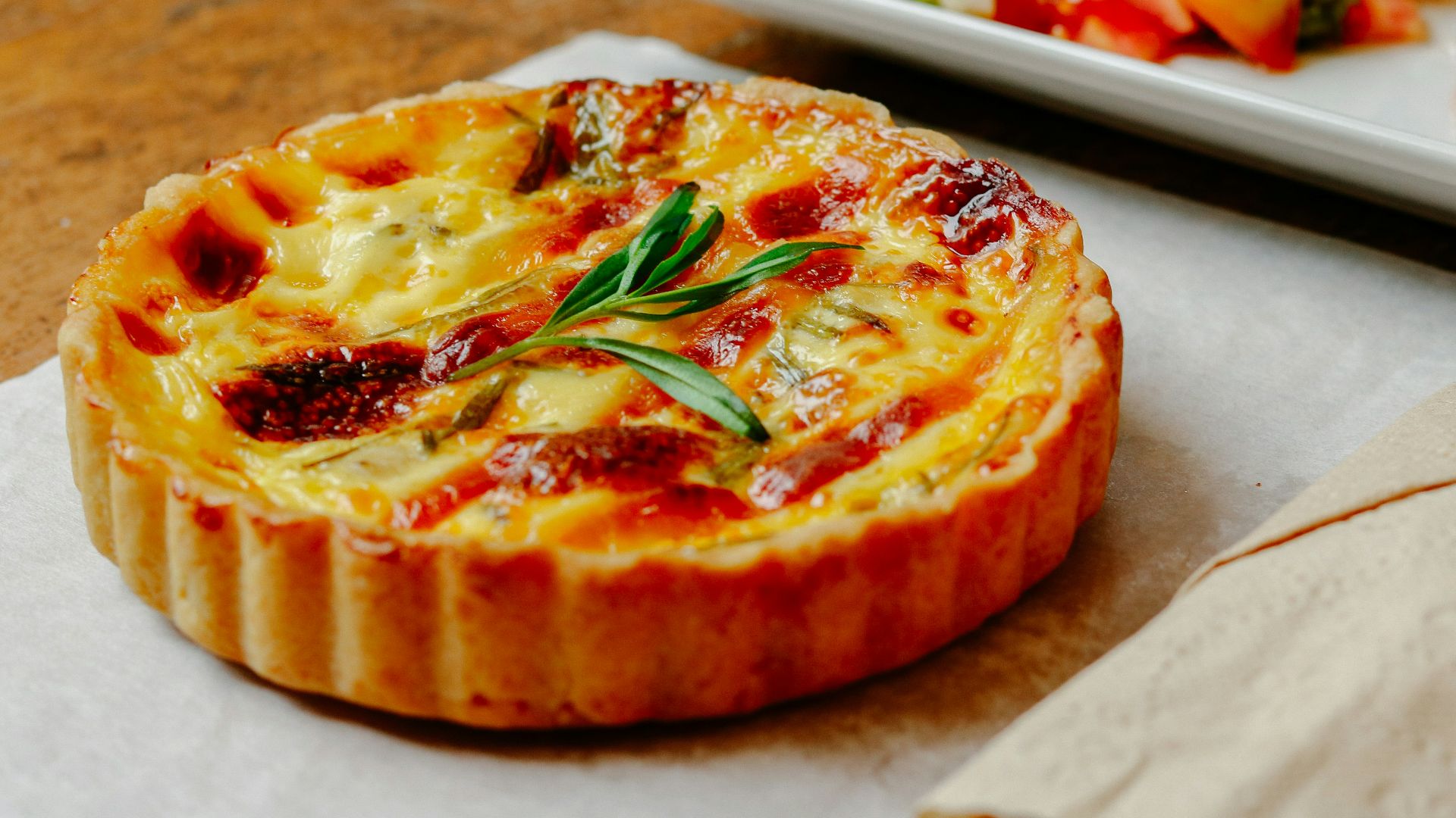 pizza with green leaf on white ceramic tray