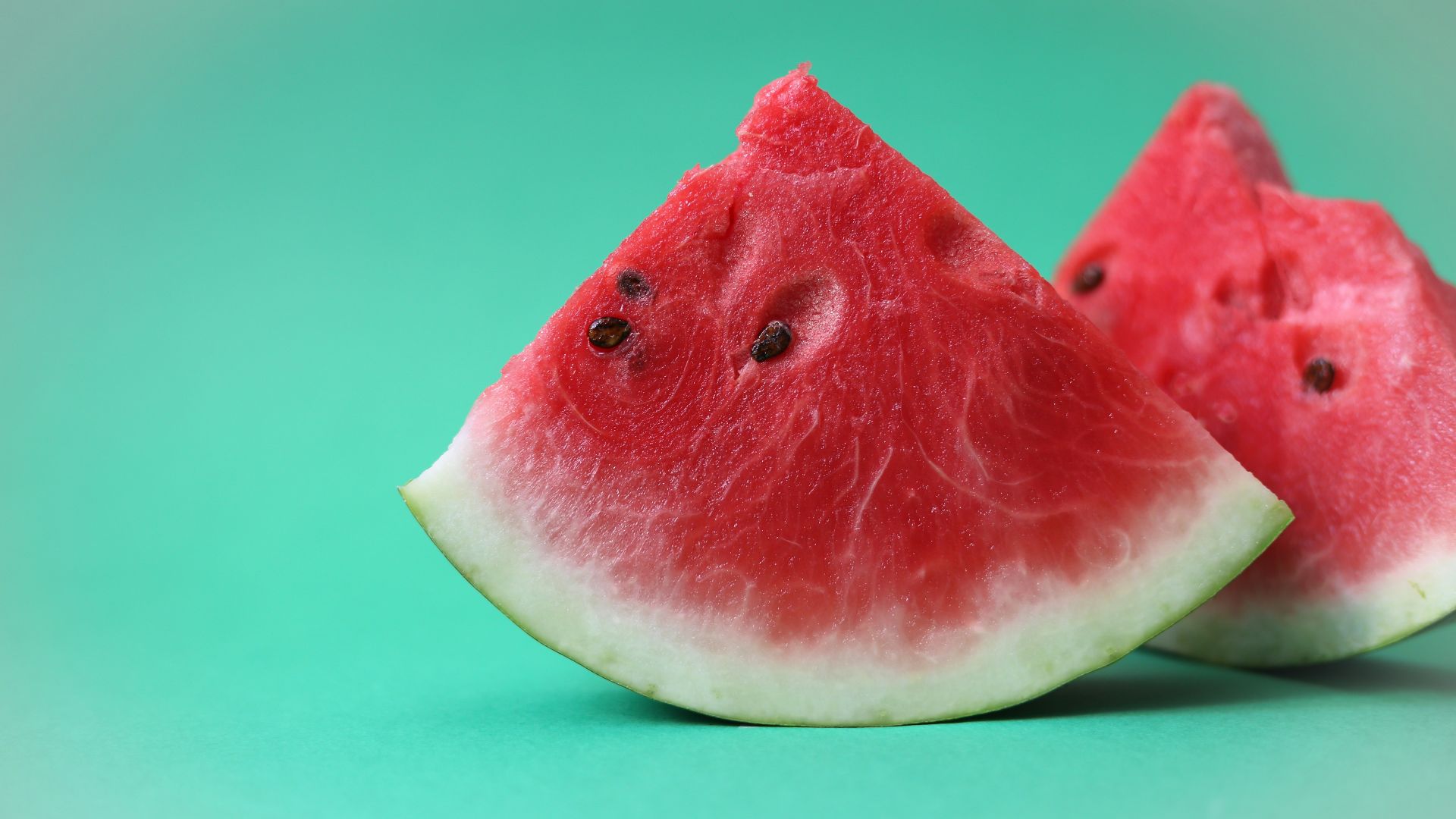 sliced watermelon on green surface