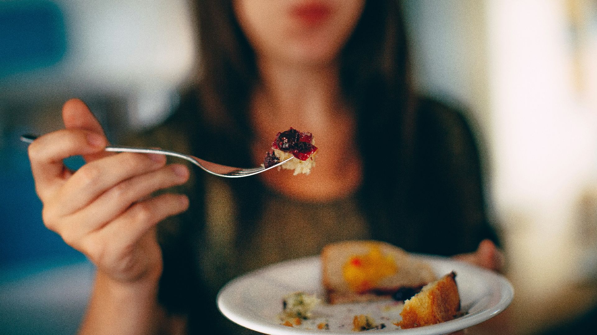 woman holding plate of cake