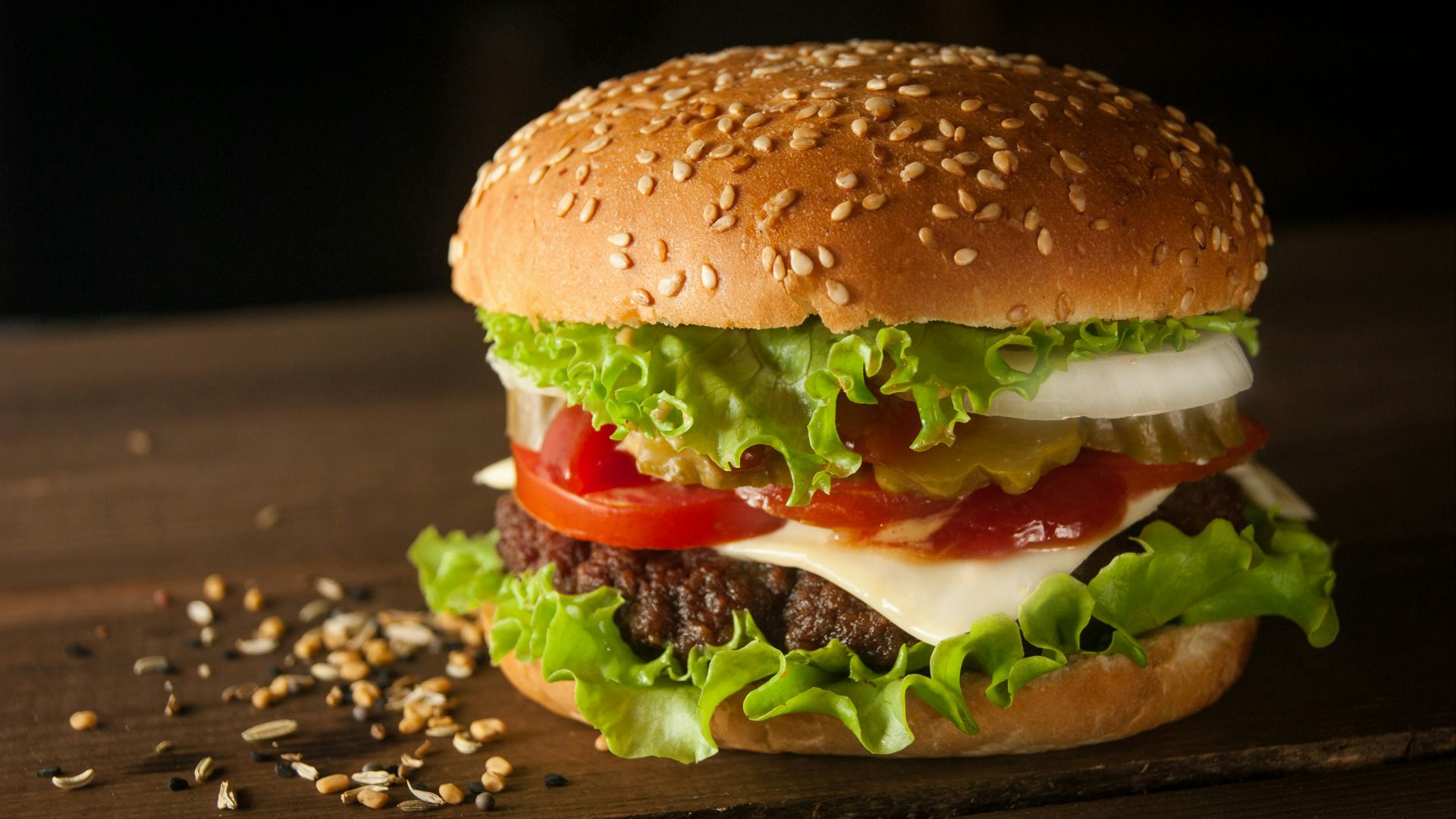 meat and cheese burger surrounded by sesame seeds