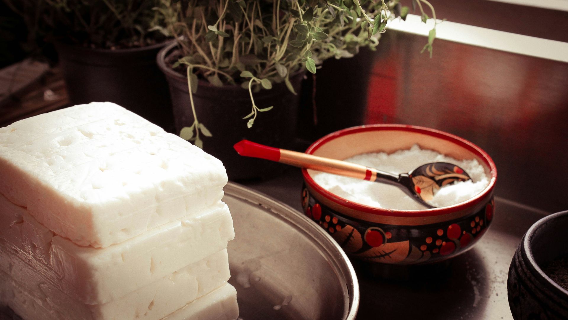 red ceramic bowl on gray spoon